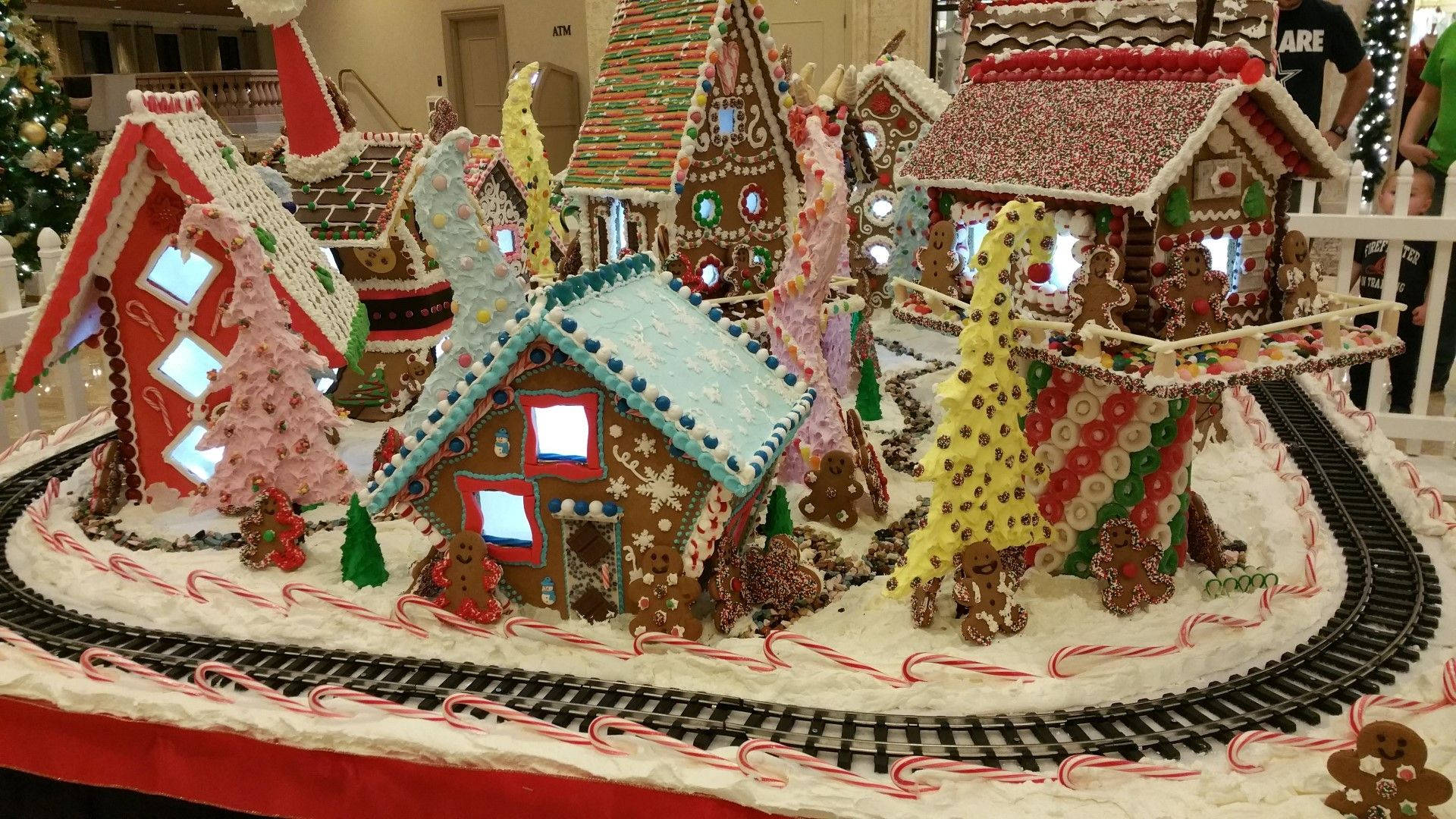 Enchanting Gingerbread House Village With Toy Train Background