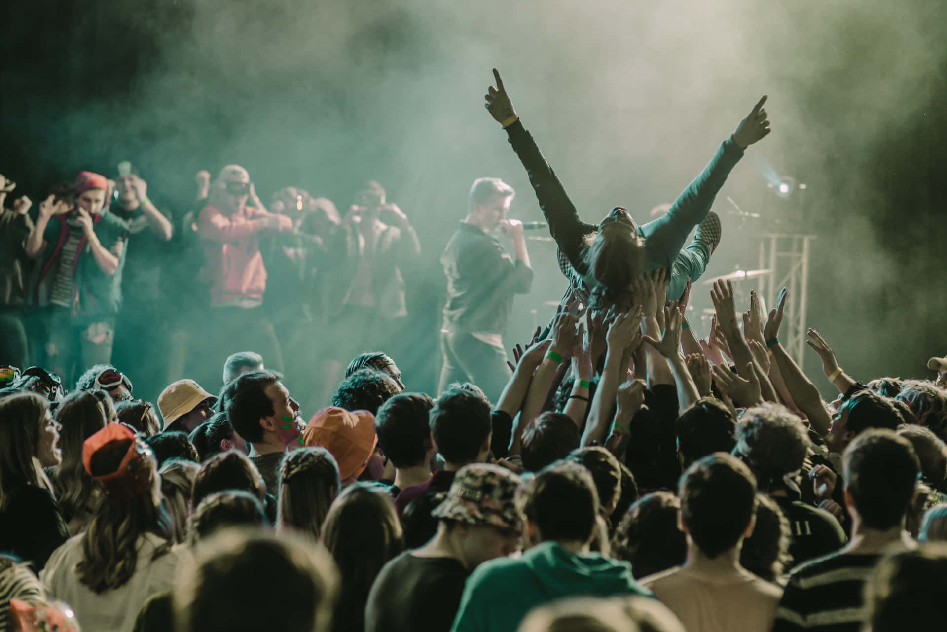 Energetic Crowd Enjoying A Live Performance At A Music Festival Background