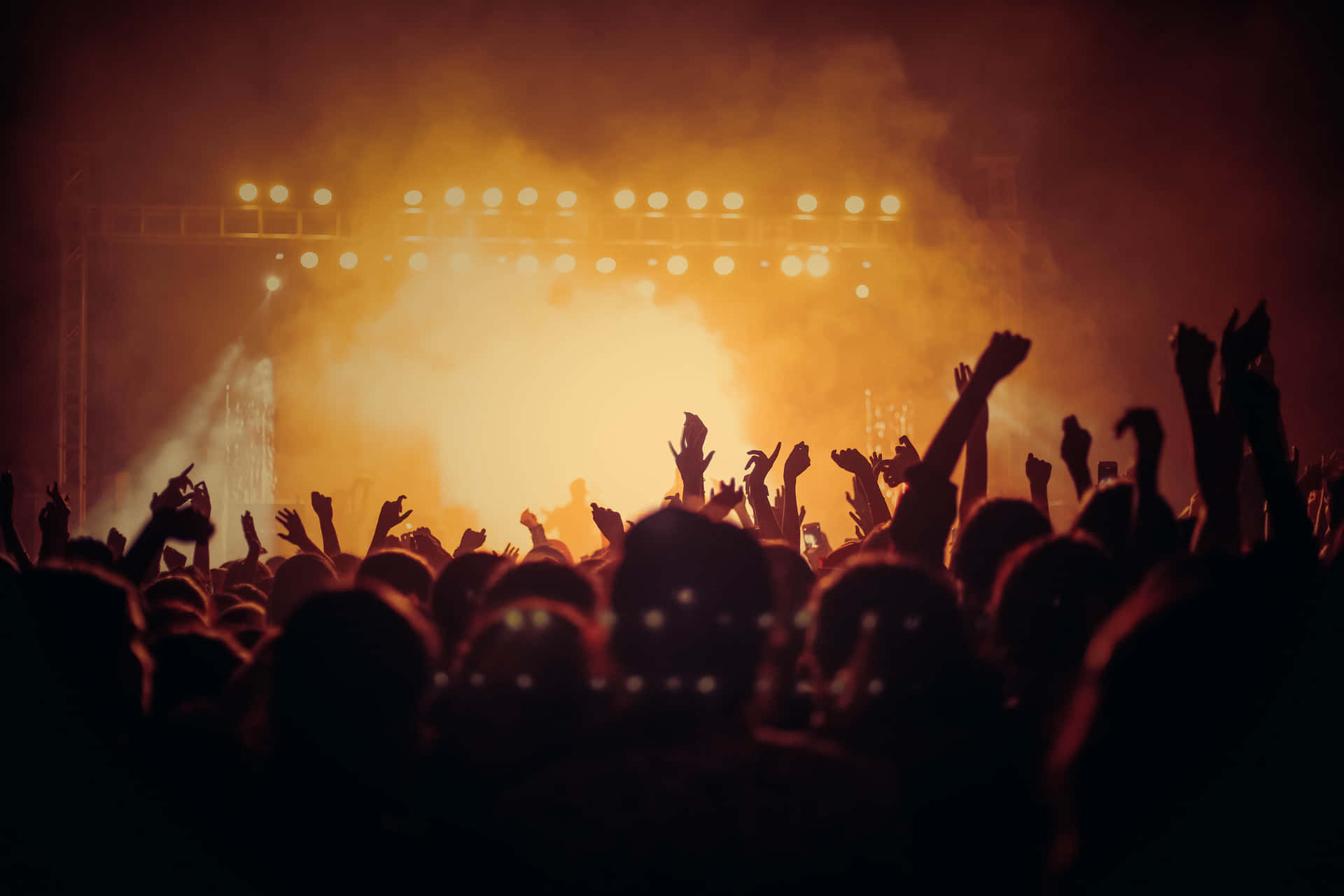 Energetic Crowd Enjoying An Electrifying Music Festival