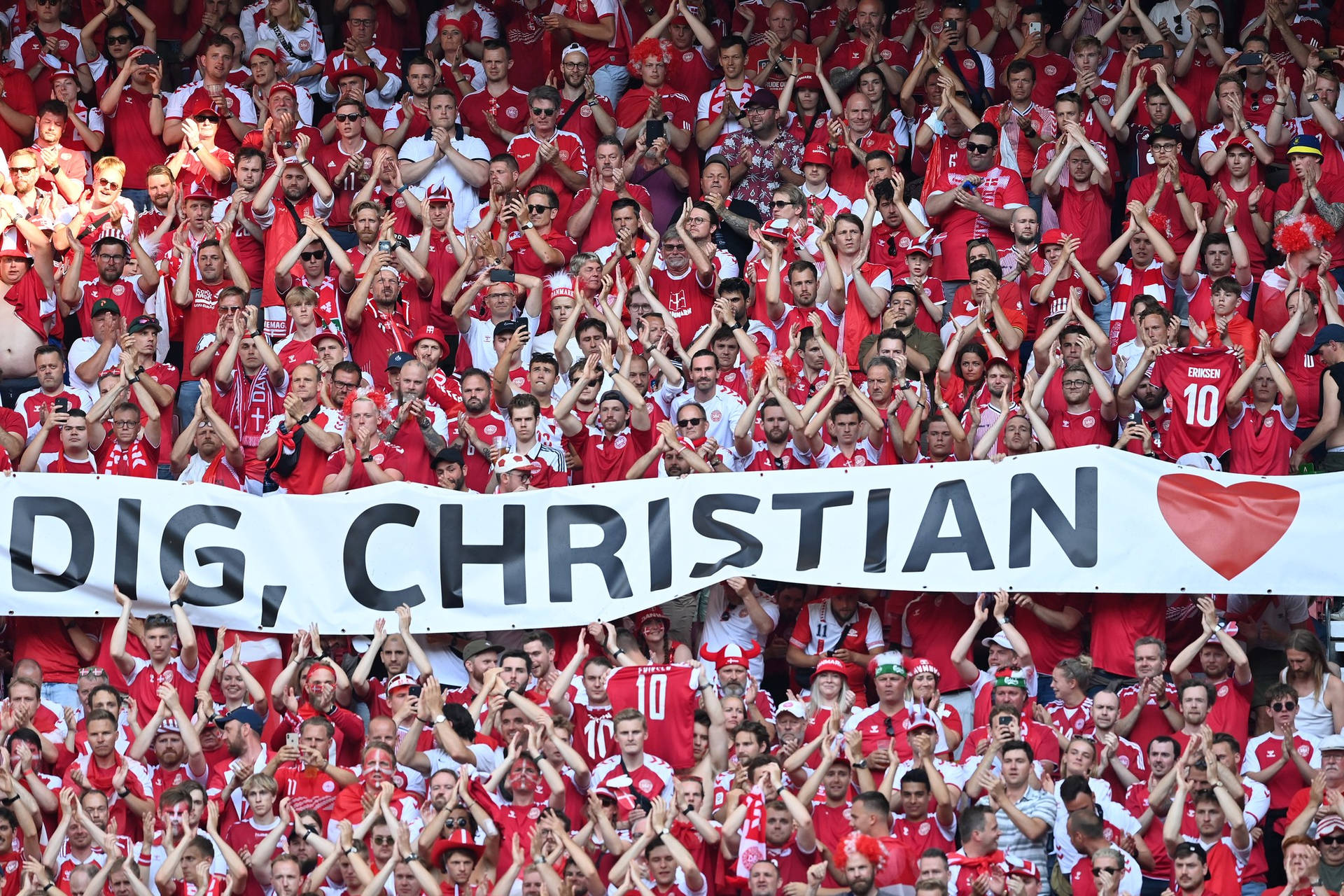 Energetic Denmark National Football Team Supporters Cheering At A Game Background