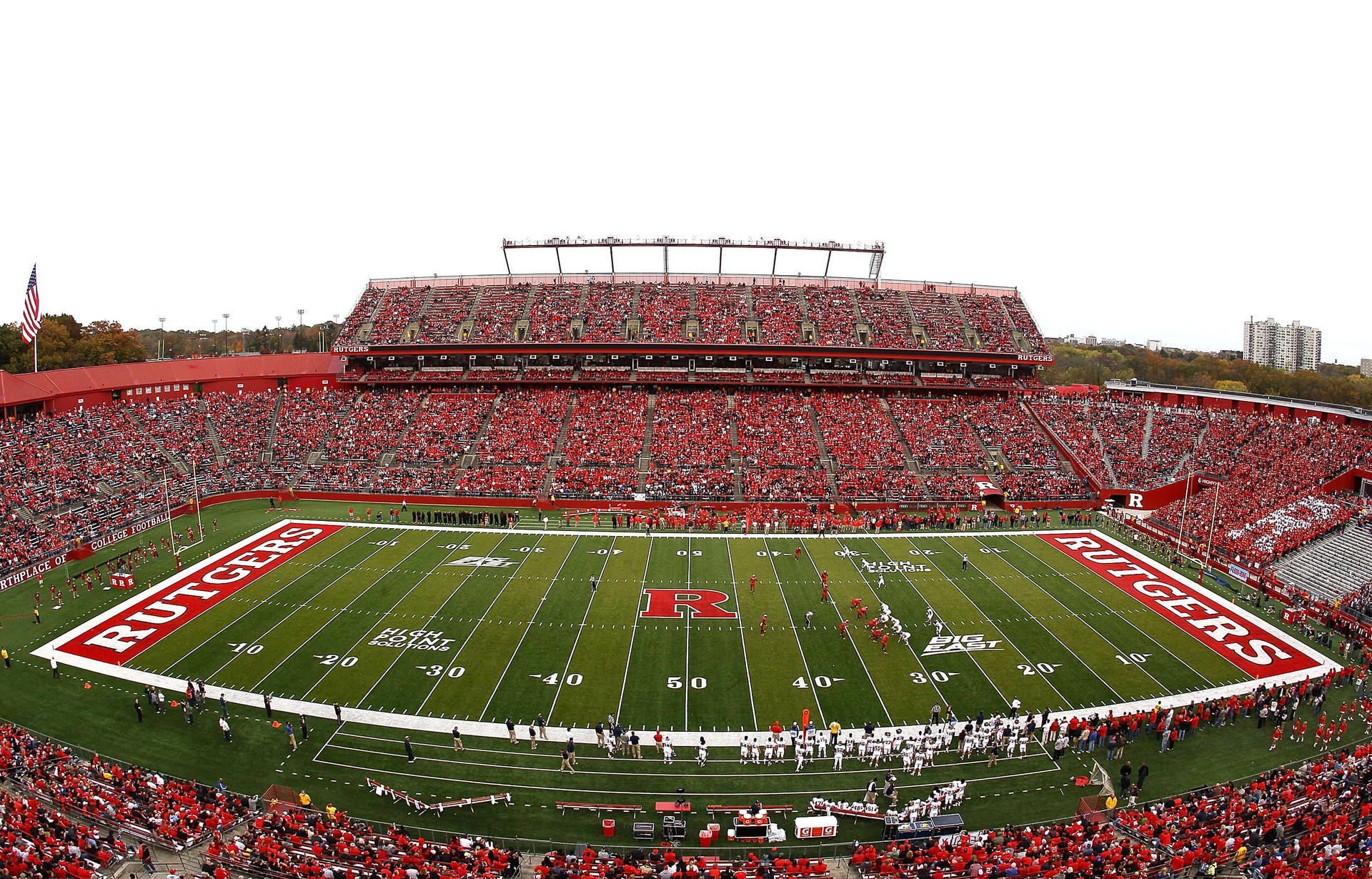 Energized Crowd At Rutgers Scarlet Knights Football Game Background