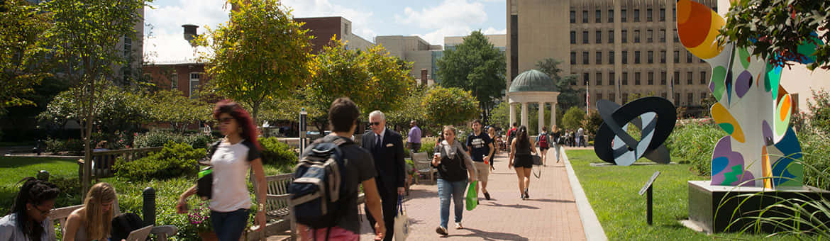 Energized Students Walking Across The Campus Of George Washington University Background