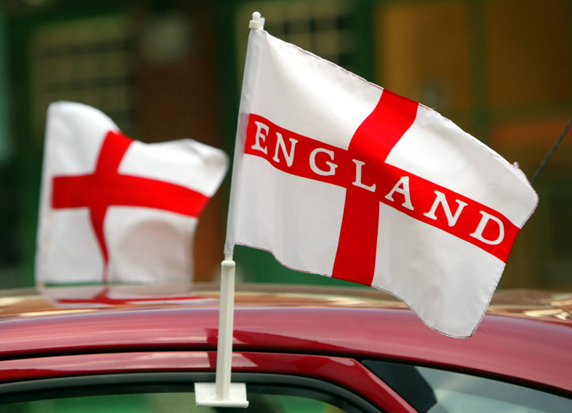 Engaging Display Of The England Flag Fluttering Against The Clear Sky Background