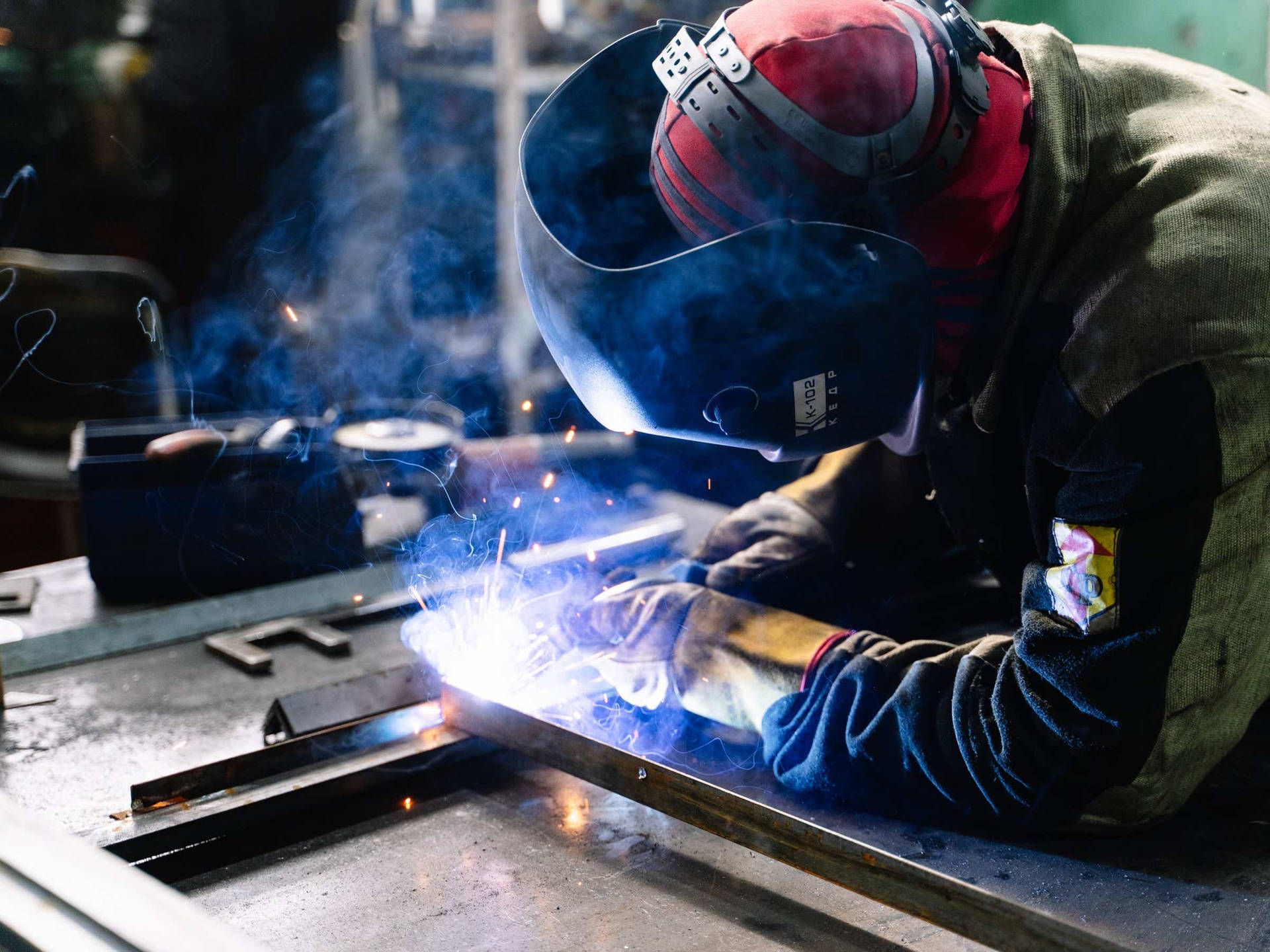 Engineer Welding A Metal Background