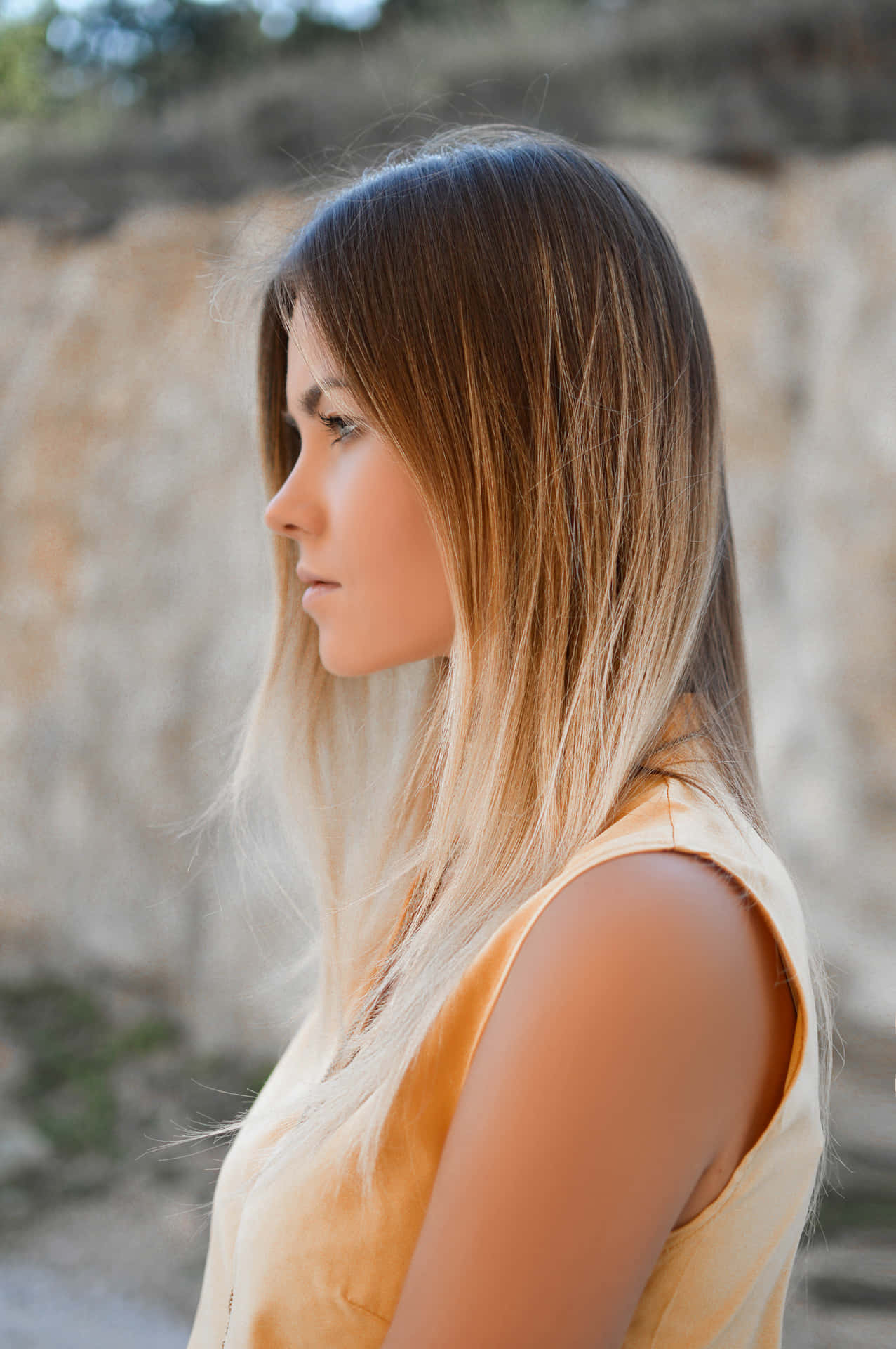 Enigmatic Beauty: Side Profile Of A Woman With Ombre Hair Background