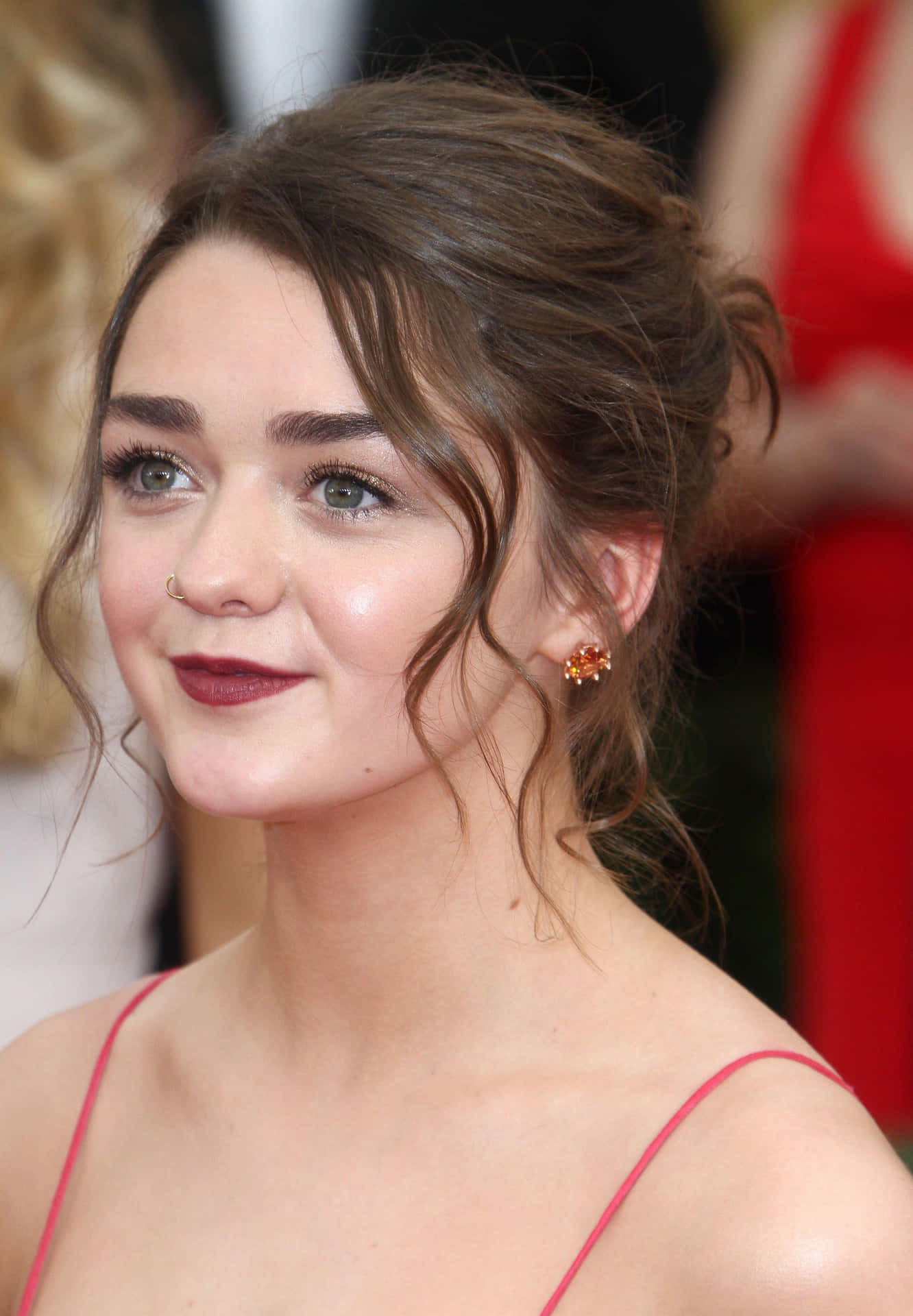 Enigmatic Maisie Williams Posing Elegantly During A Photoshoot. Background