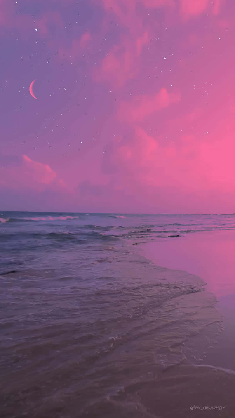 Enjoy A Beautiful Beach Sunset With A Pink And Tranquil Aesthetic.