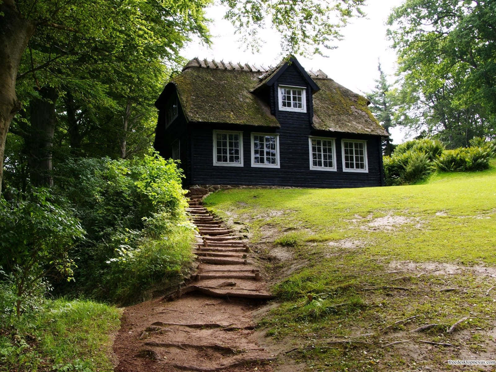 Enjoy A Beautiful Homely Landscape Surrounding A Classic Farmhouse. Background