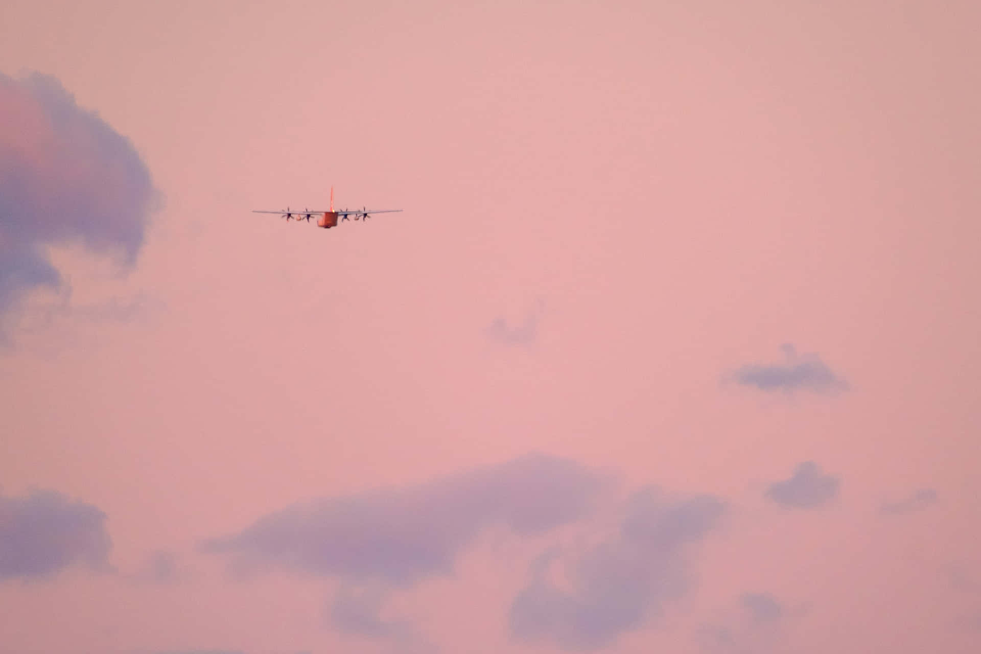 Enjoy A Beautiful Sunset Flight With Pink Plane Background