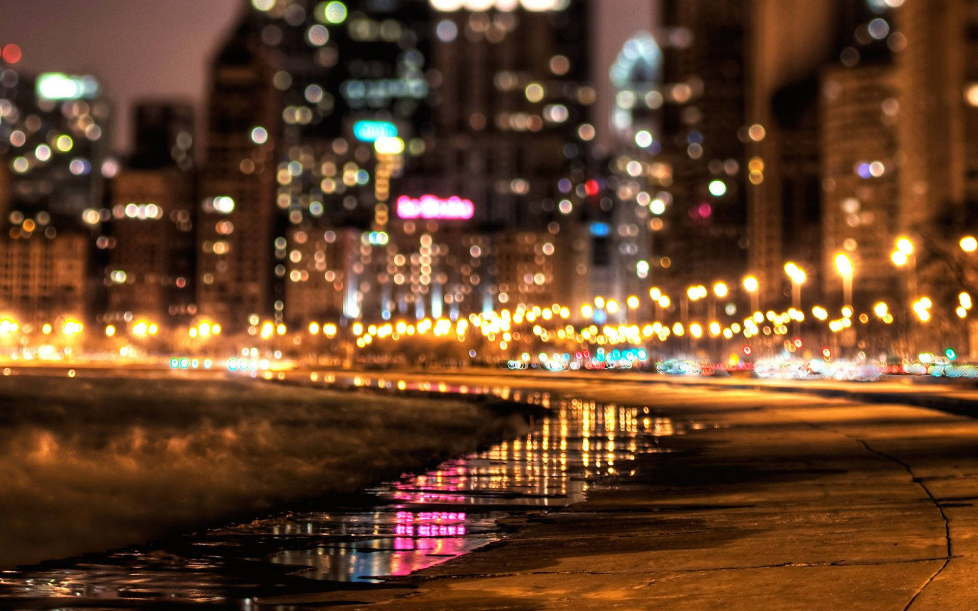 Enjoy A Peaceful Stroll Under The Street Lights Along A Beachside Street Background
