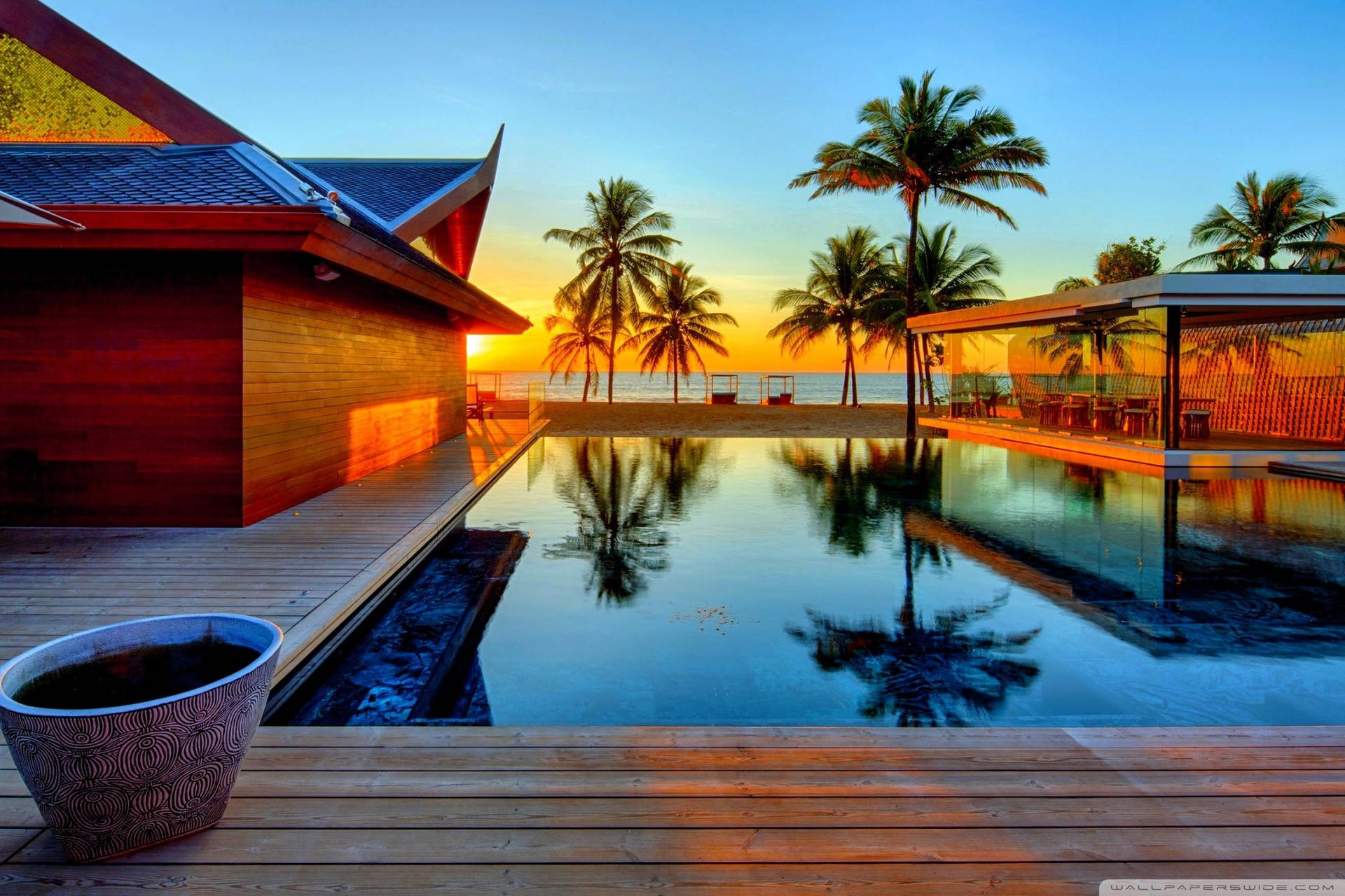Enjoy A Scenic View From A Relaxing Pool House Background