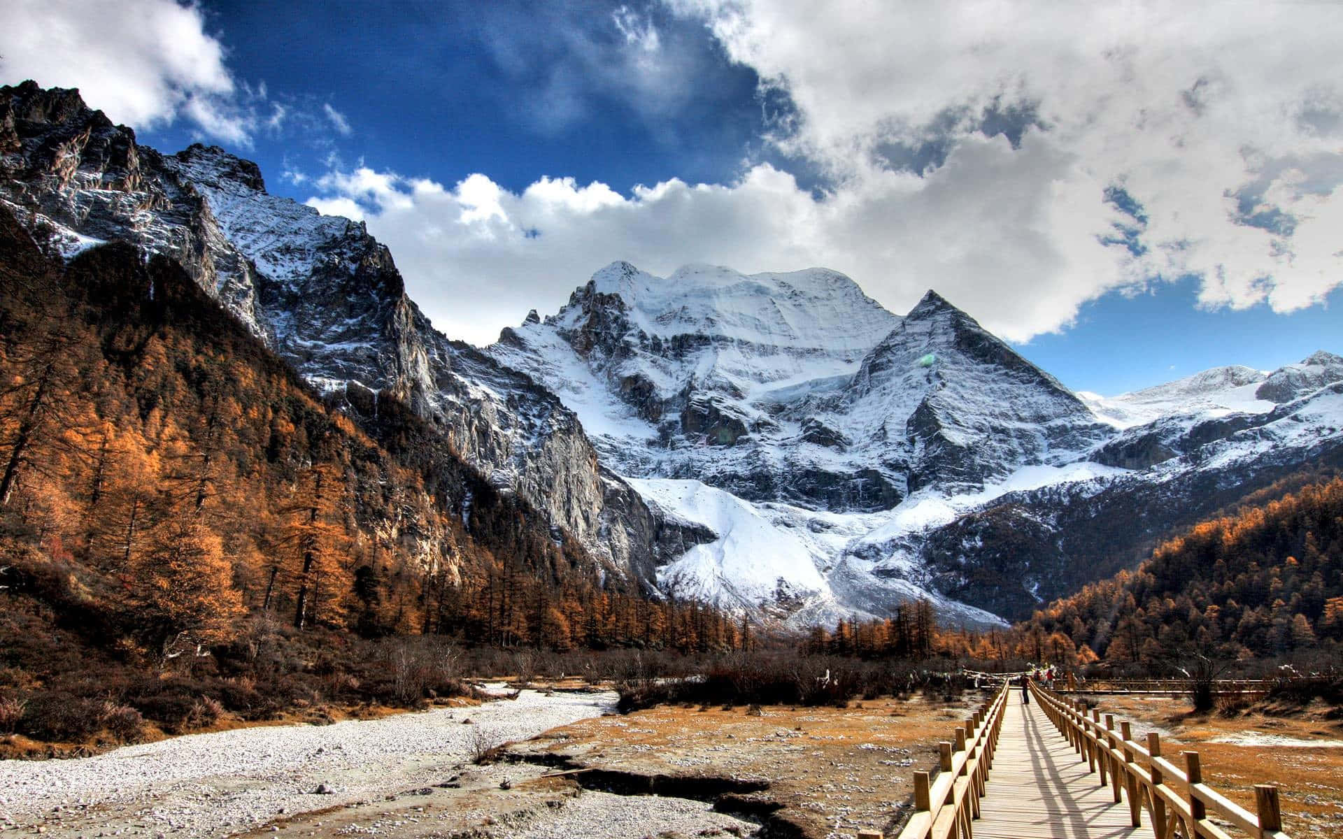 Enjoy A Serene Landscape Of Snow-capped Mountains Background