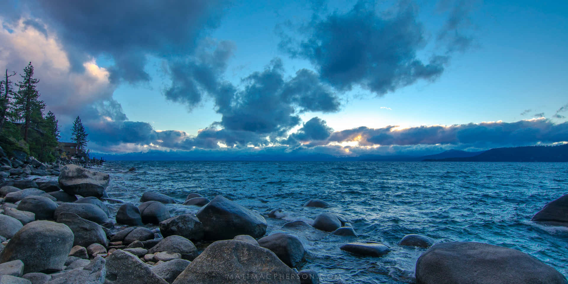 Enjoy An Enchanting View Of Lake Tahoe Reflecting The Setting Sun Background