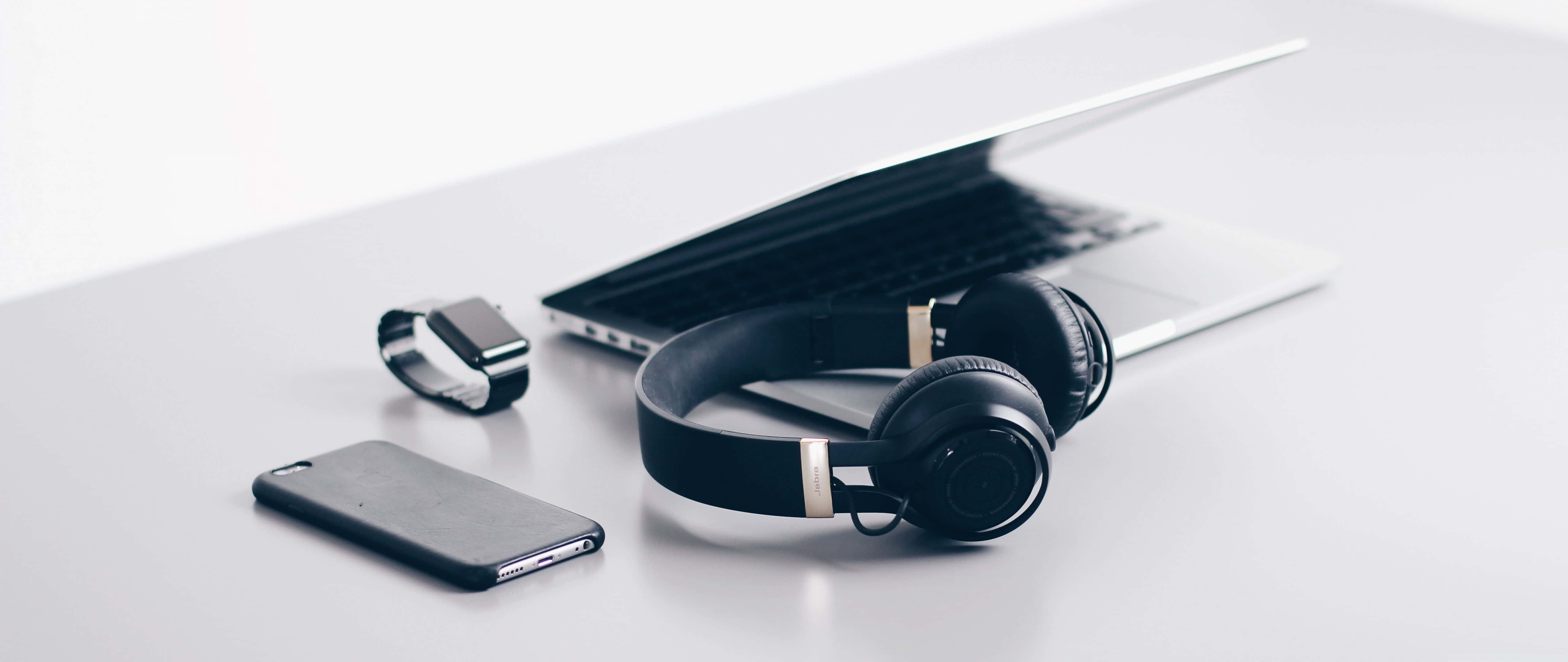 Enjoy Music And Technology With A Laptop And Headphones