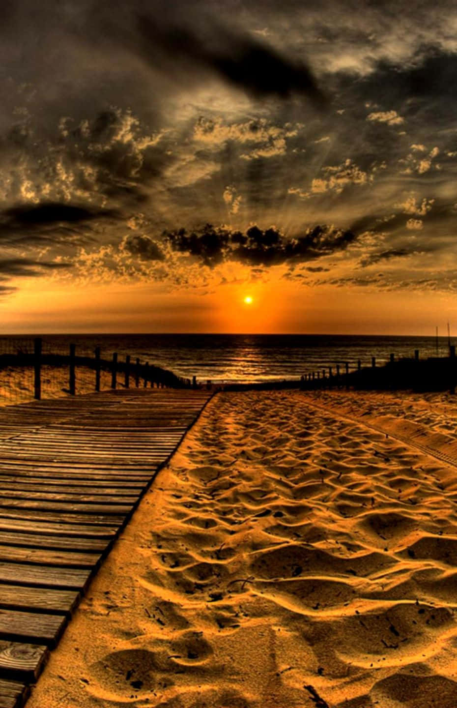 Enjoy The Beautiful View Of Sunset At The Beach With Your Brand New Iphone Background