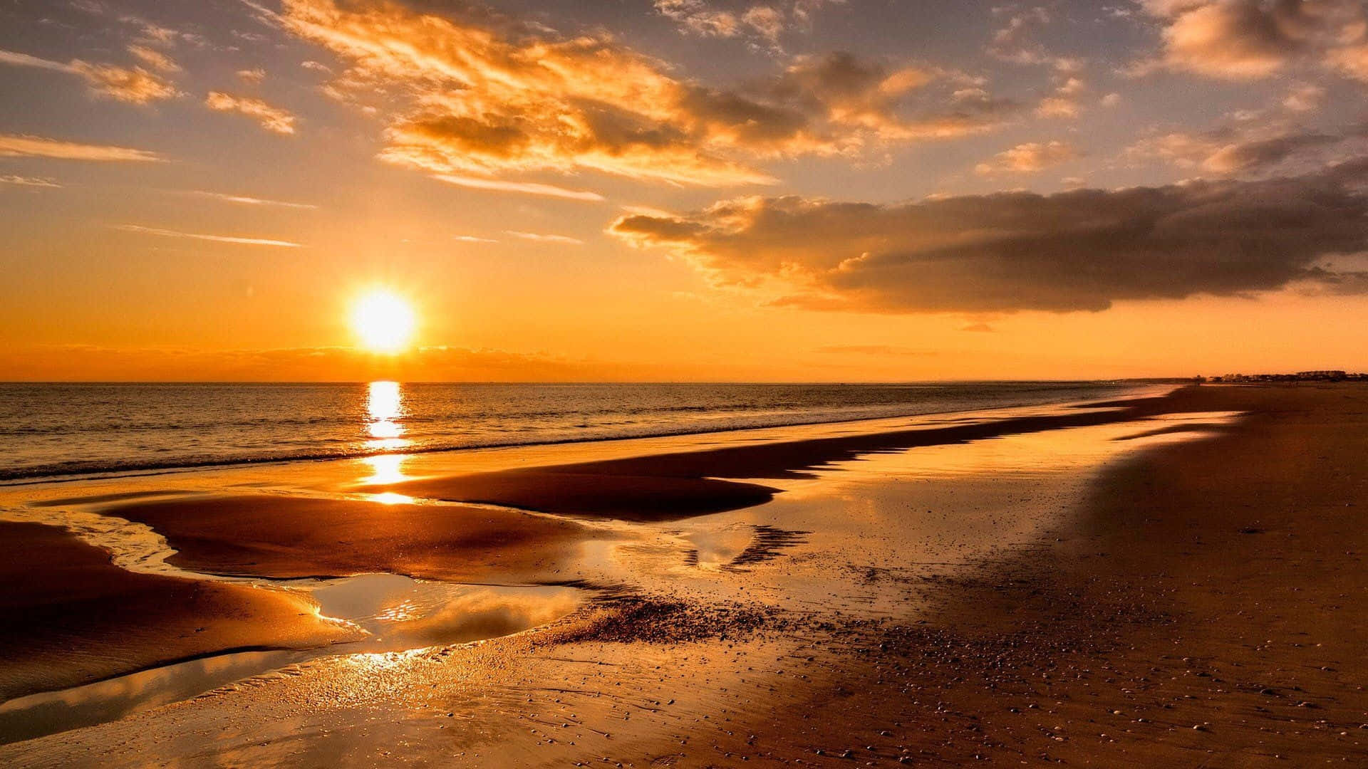 Enjoy The Beauty Of A Spectacular Beach Sunset Background