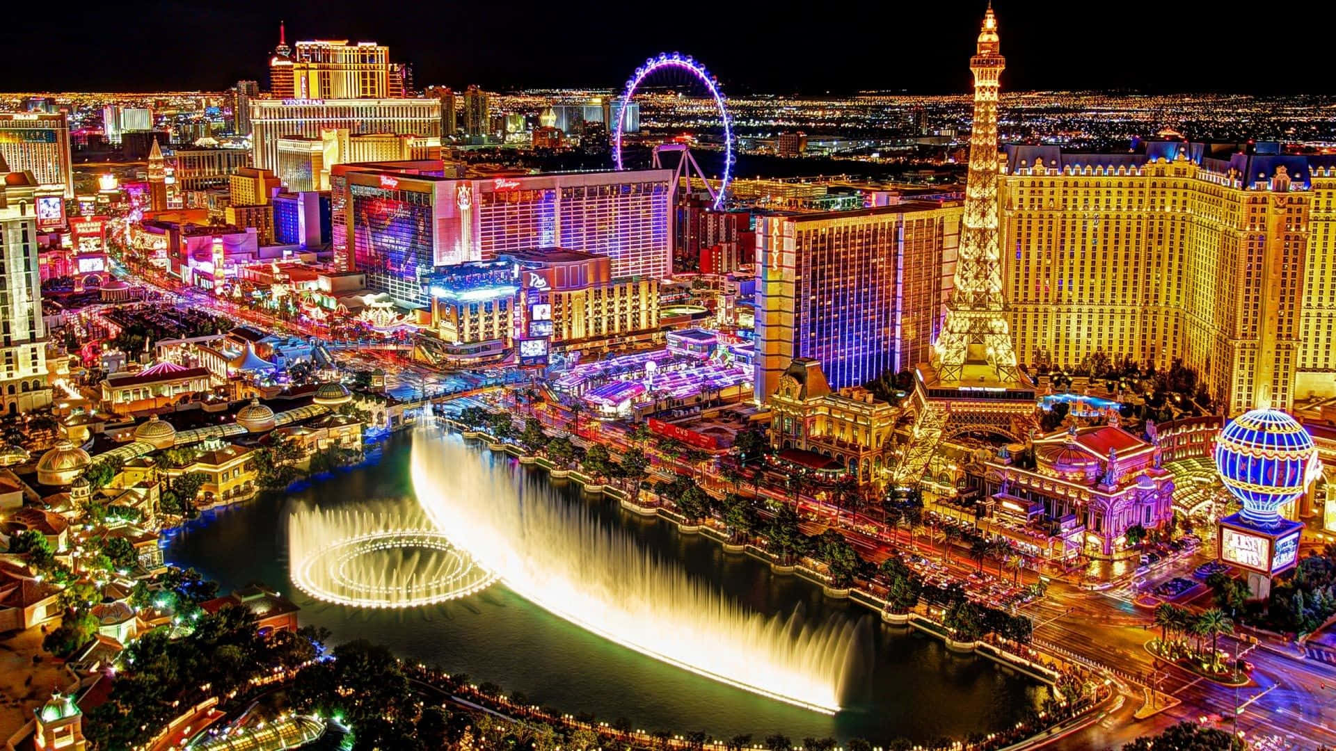 Enjoy The Beauty Of Las Vegas Lit Up Against A Starry Night Sky. Background