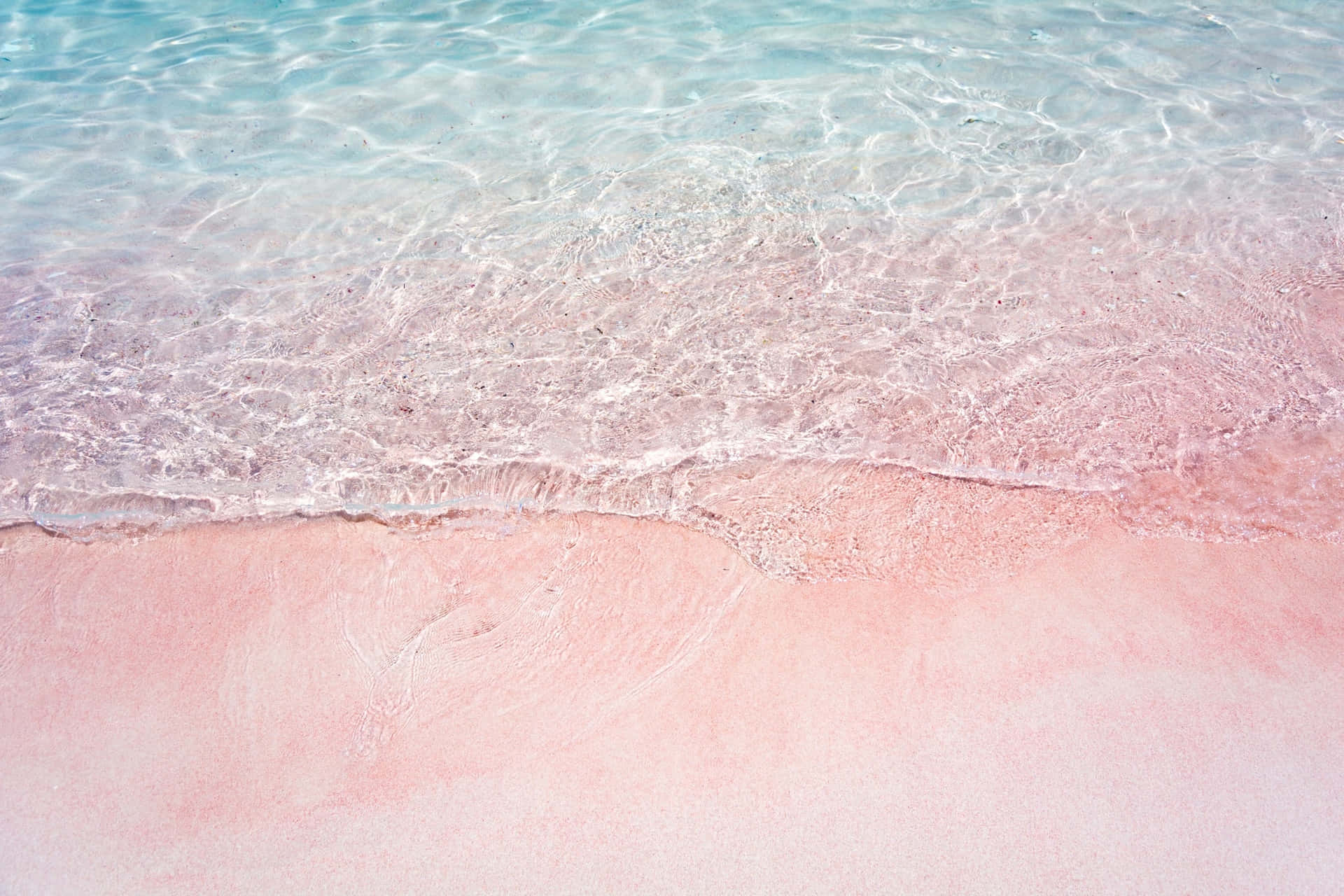 Enjoy The Calming Beauty Of A Pink Beach. Background