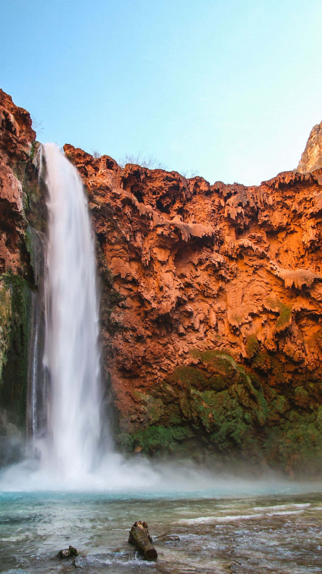 Enjoy The Peaceful Beauty Of Nature With A Breathtaking View Of A Waterfall Background