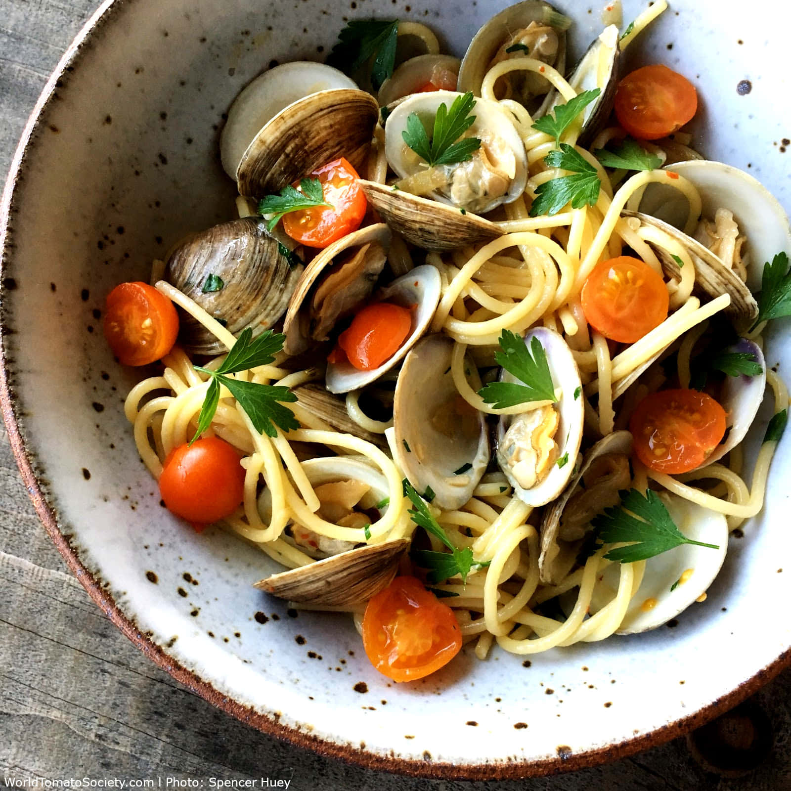 Enjoy The Rich Blend Of Fresh Ingredients In Our Spaghetti Alla Vongole With Cherry Tomatoes. Background