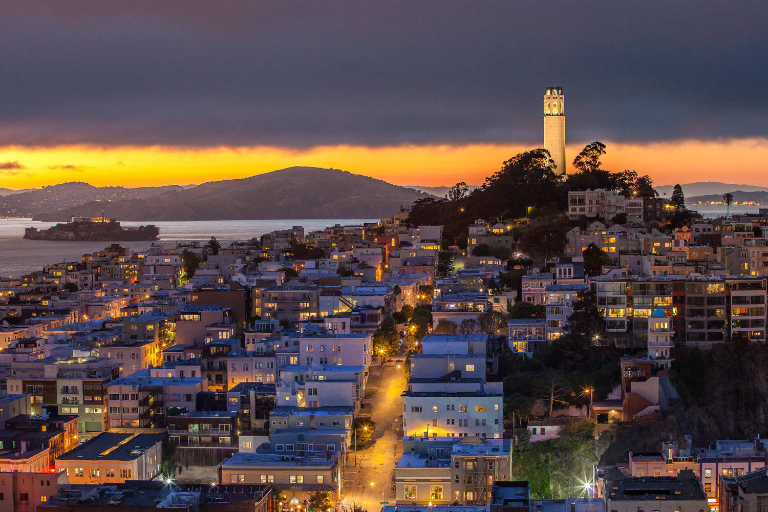 Enjoy The Vibrant Night Sky And Stunning Views From Coit Tower! Background