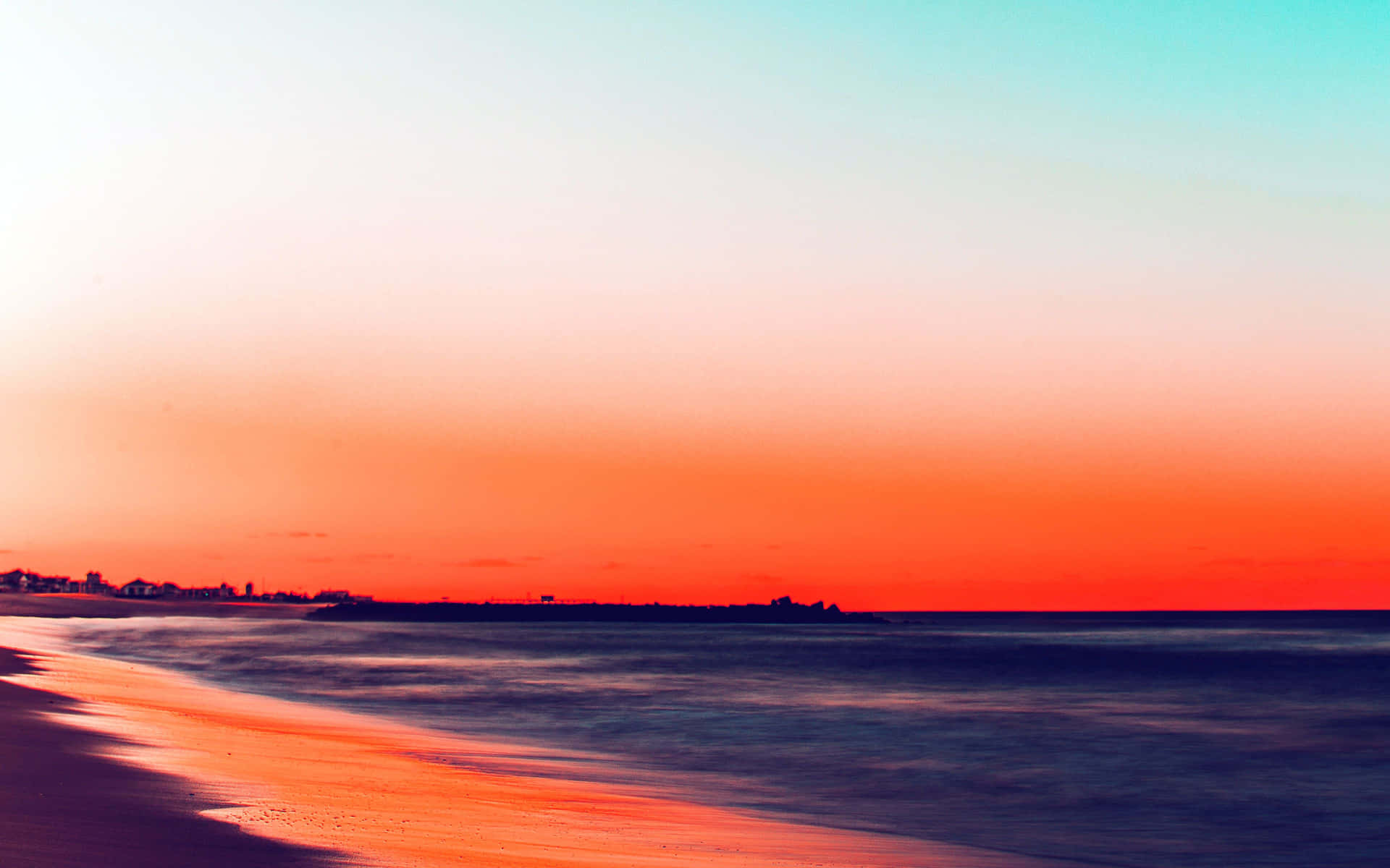 Enjoying A Beautiful Beach Day With A Laptop Background