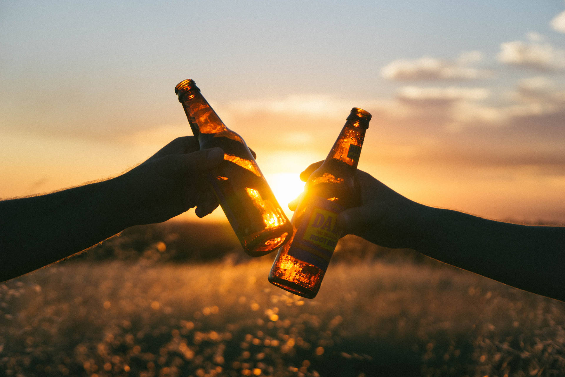 Enjoying A Beer At Sunset Background