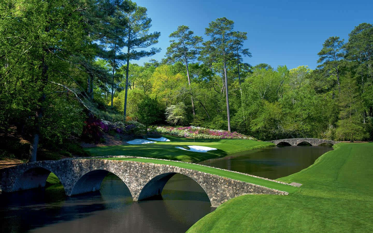 Enjoying A Day Of Golf At Augusta National’s Lush Landscape Background