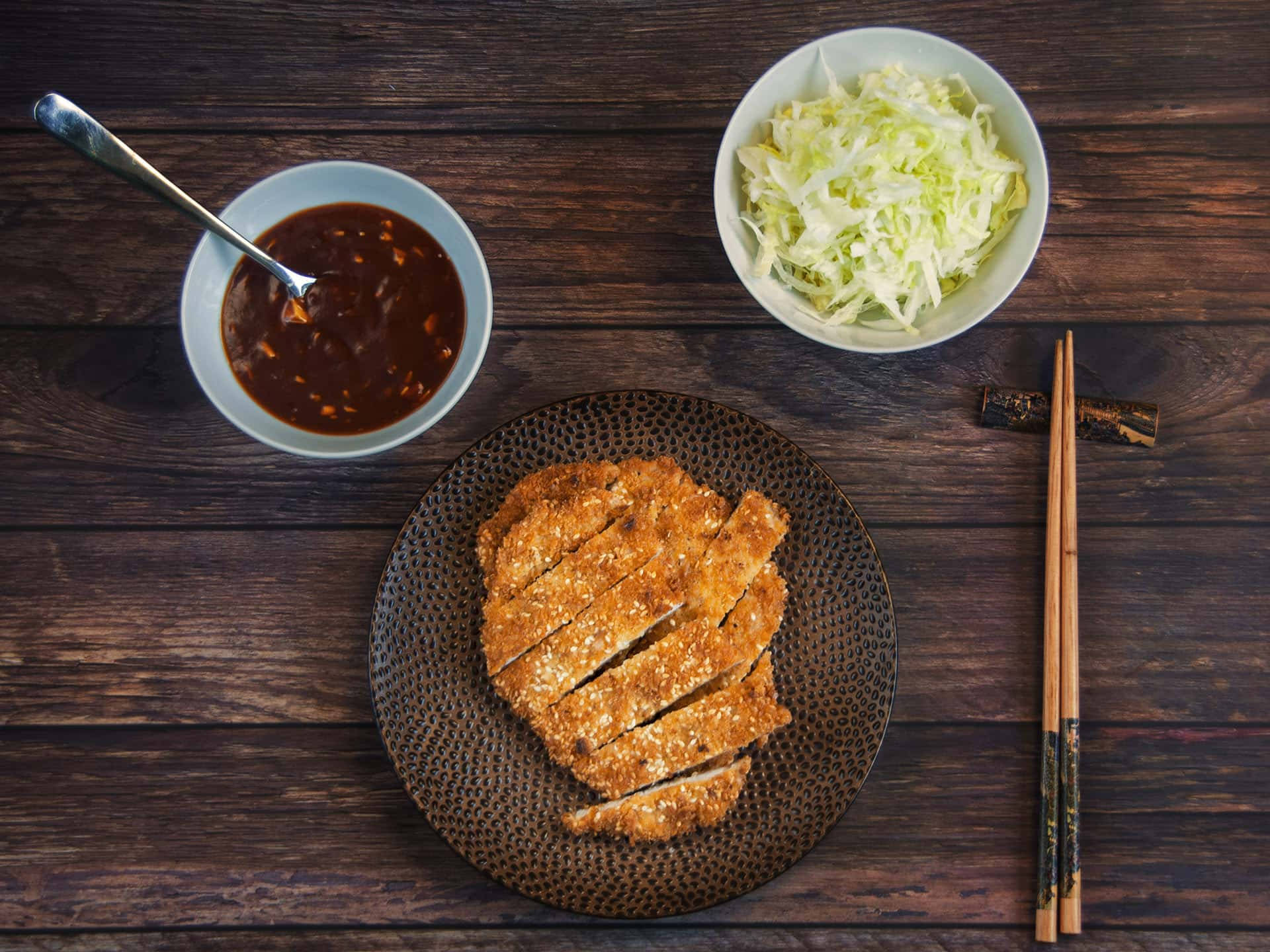 Enjoying A Delicious Plate Of Tonkatsu Background