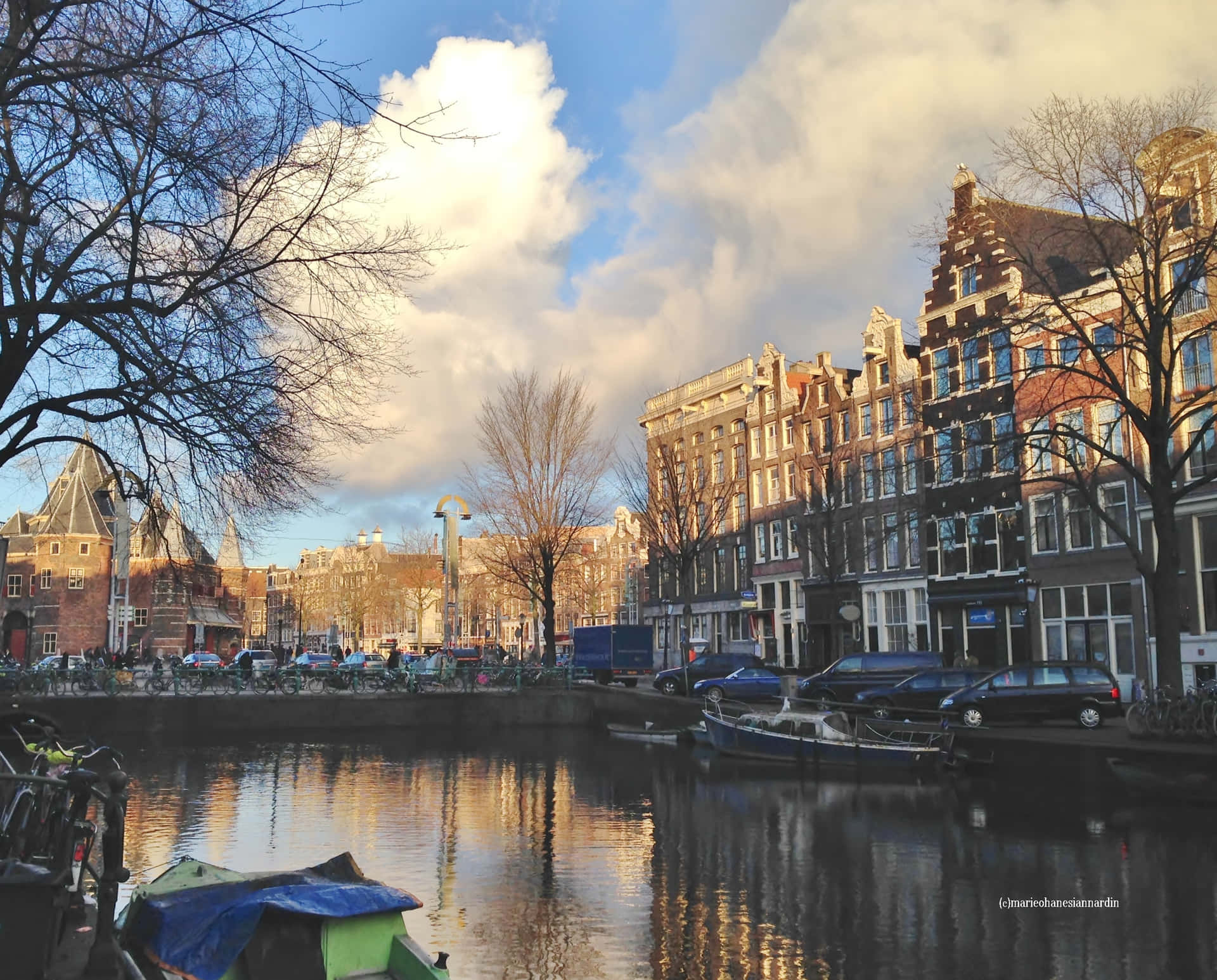 Enjoying A Sunny Spring Day By A Canal In Amsterdam Background