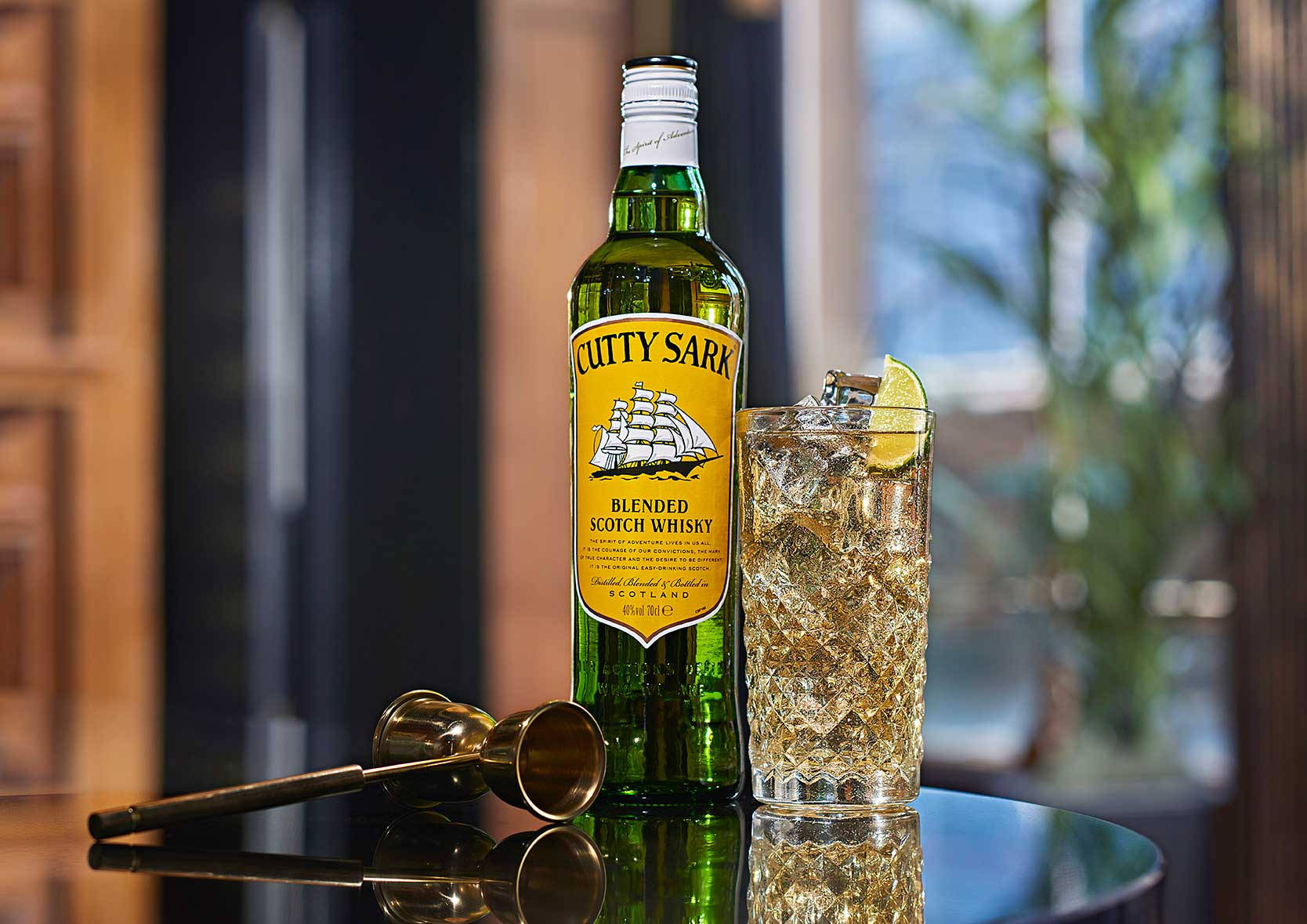 Enjoying Cutty Sark Whisky Cocktail With Brass Pipe Background