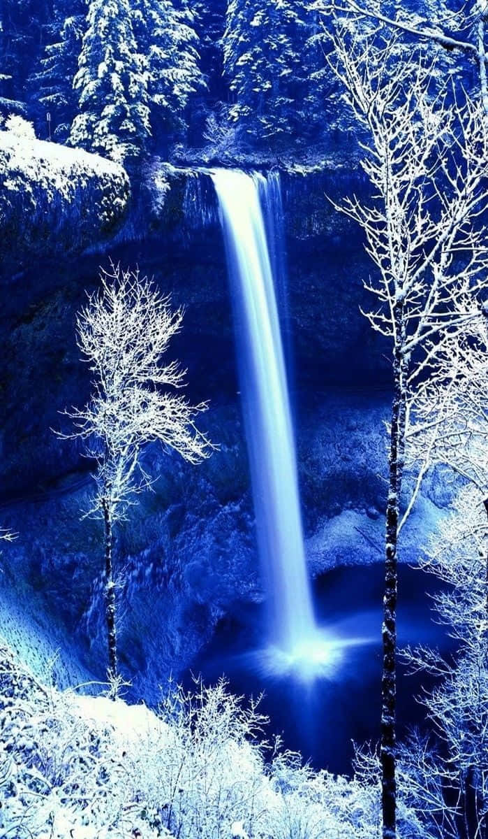 Enjoying Nature's Beauty - An Iphone Photograph Of A Waterfall Background