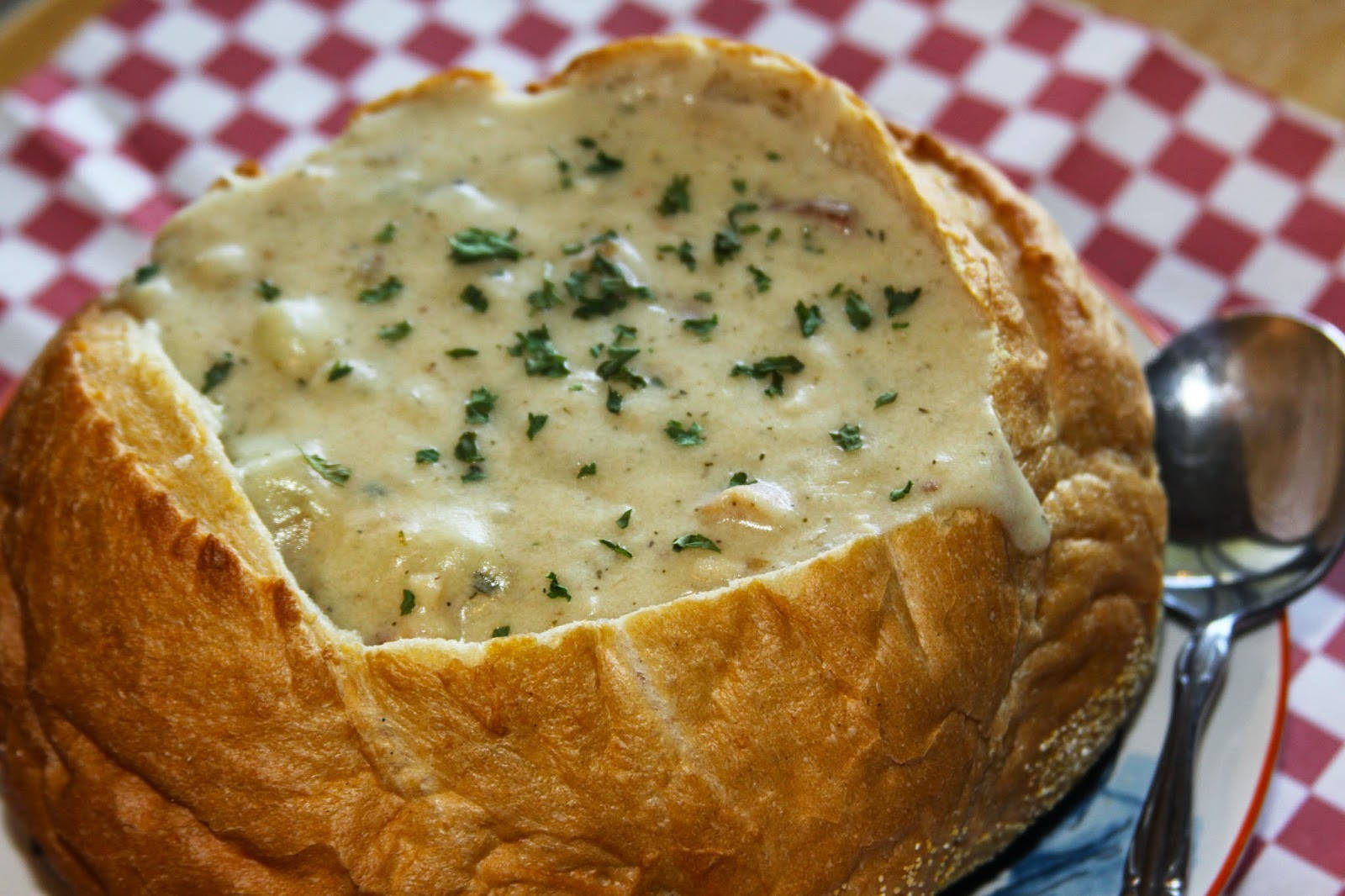 Enjoying New England Clam Chowder Served In A Bread Bowl.