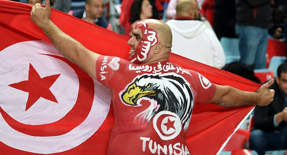 Enthusiastic Fan Cheering For Tunisia National Football Team Background