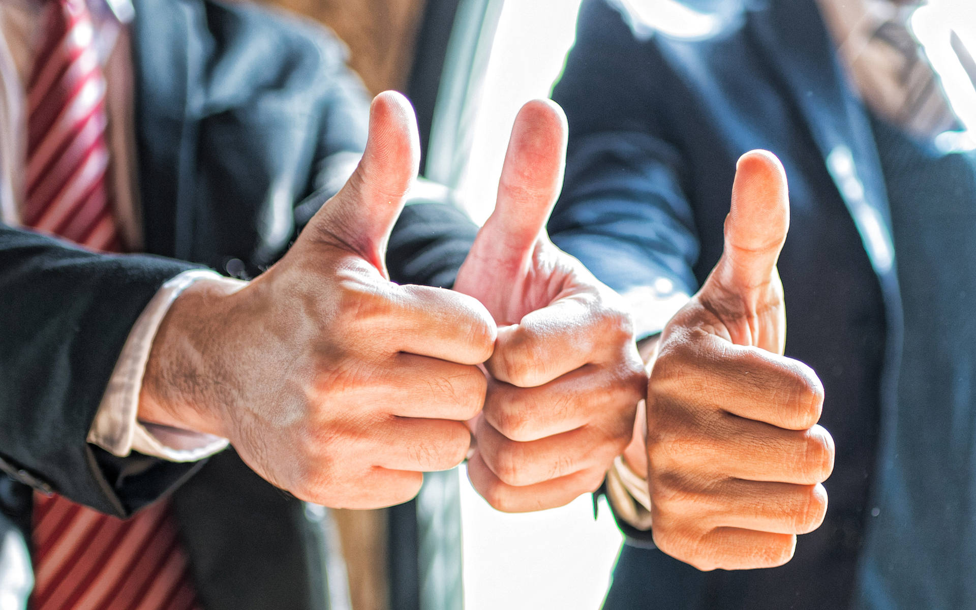 Enthusiastic Team Giving Thumbs-up In Success Background