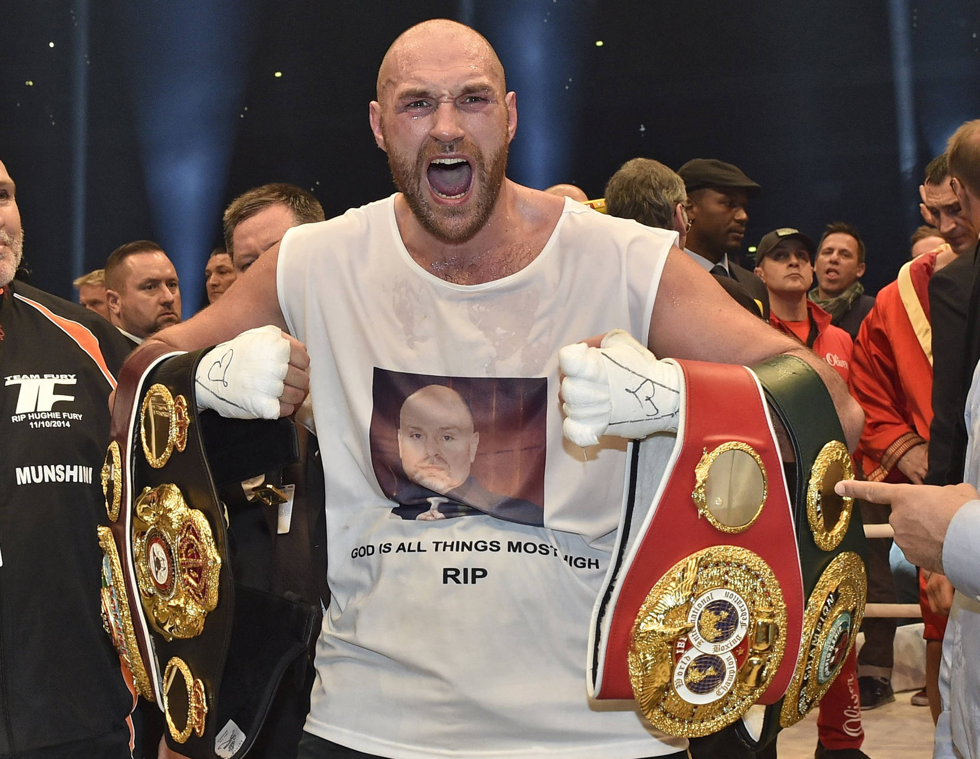 Enthusiastic Tyson Fury Carrying Title Belts Background