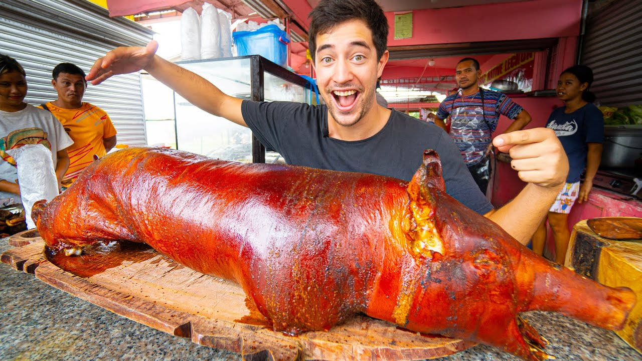 Enthusiastic Vlogger Experiencing Authentic Lechon