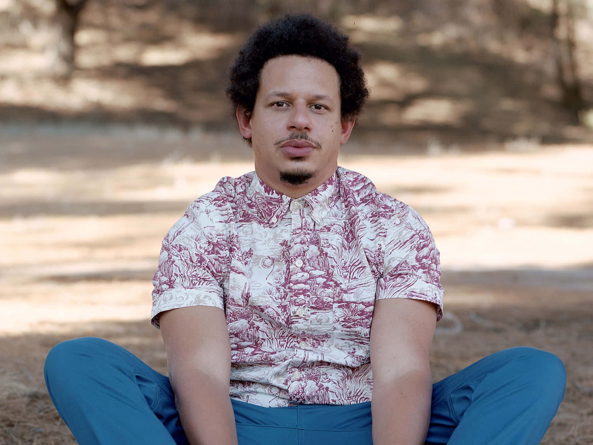 Eric Andre Sitting Outdoors Background