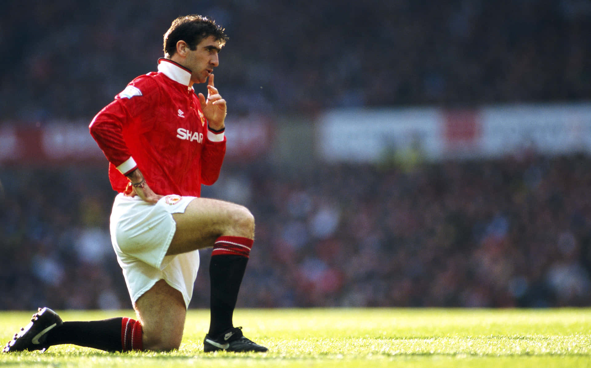 Eric Cantona In One Knee Background