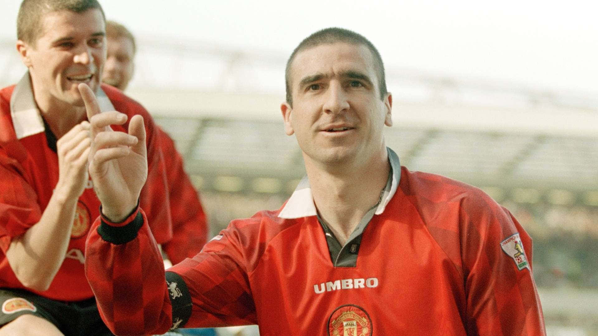Eric Cantona With Teammate Background