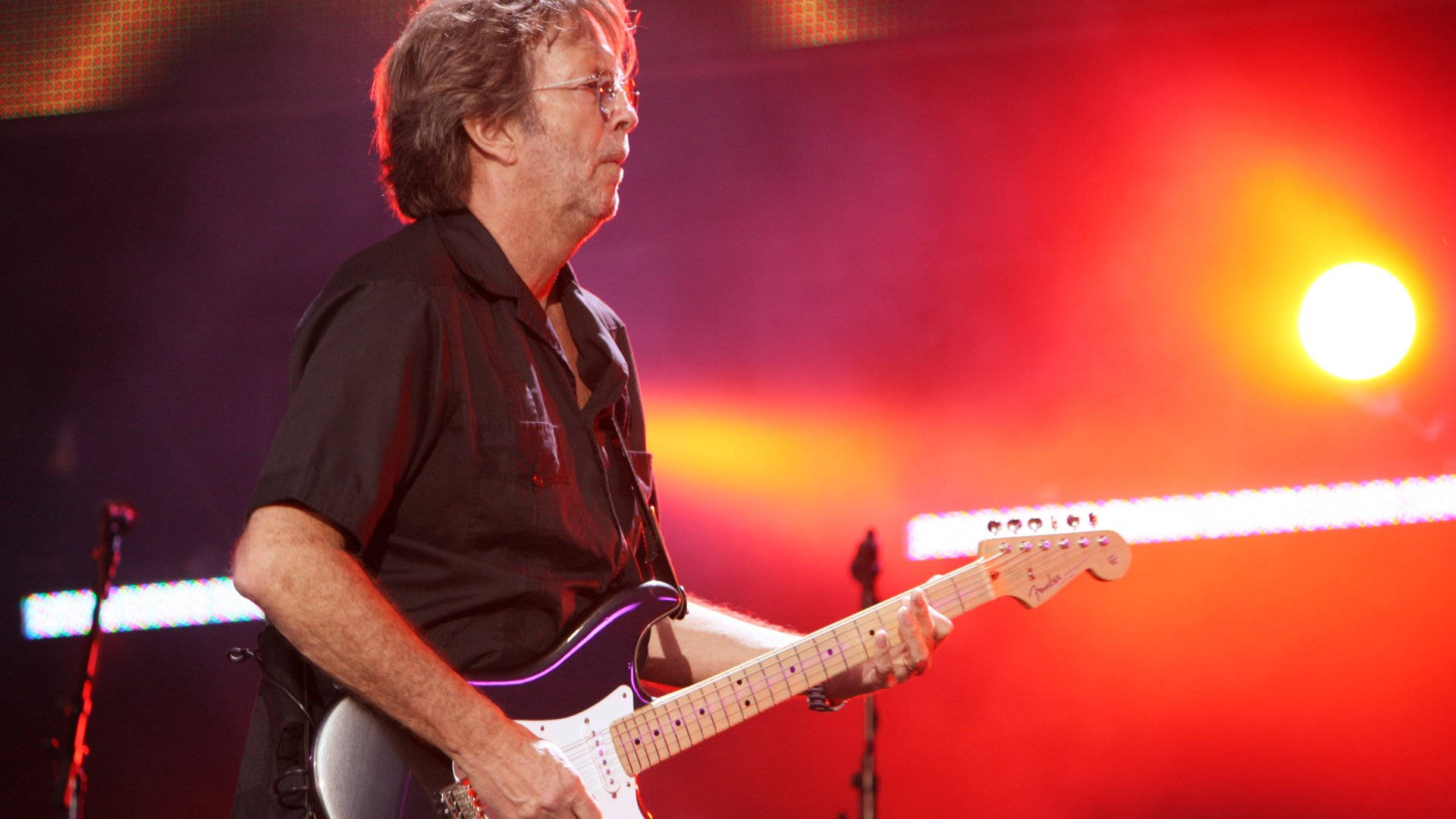 Eric Clapton Against Vibrant Orange Light