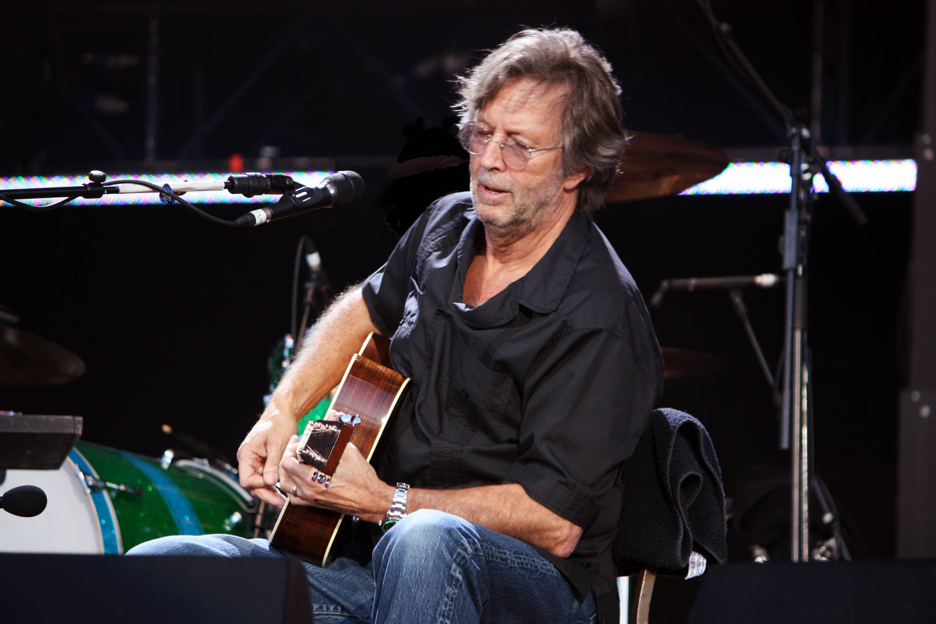 Eric Clapton Guitarist In Black Polo Background