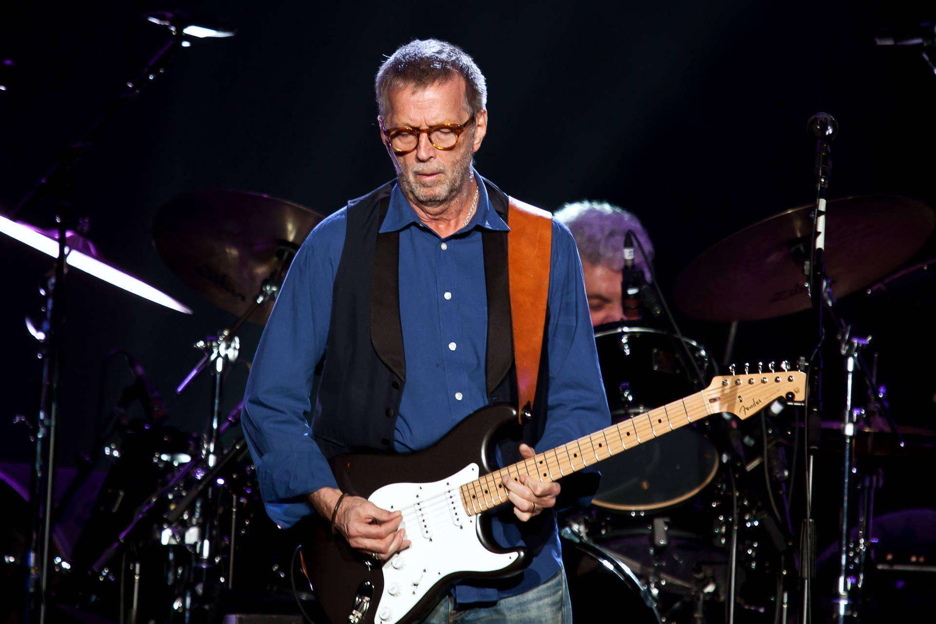 Eric Clapton Performing On Stage Background