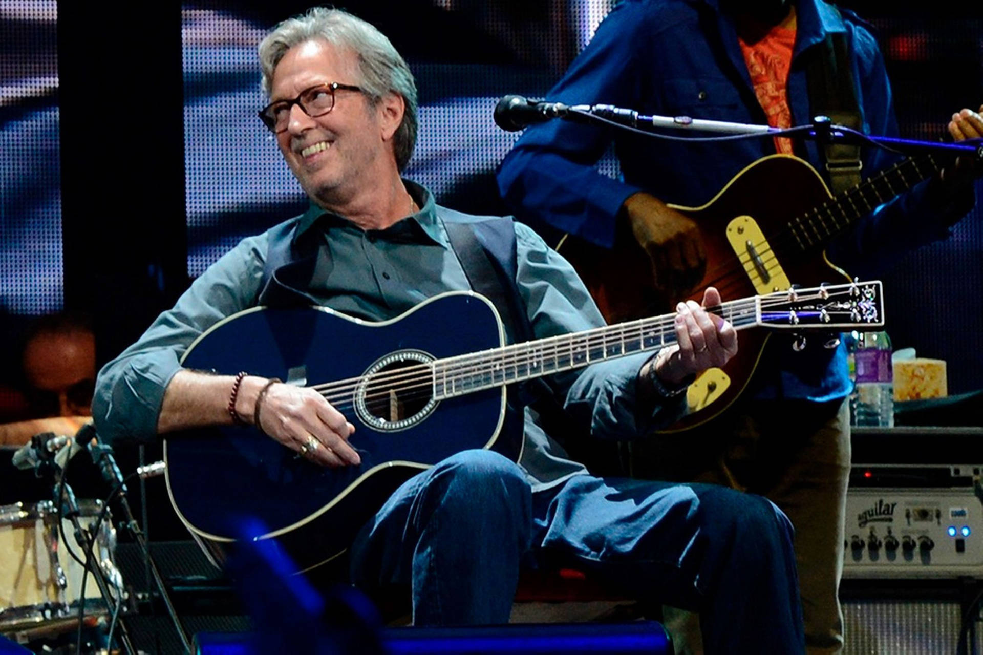 Eric Clapton Playing Blue Guitar Background