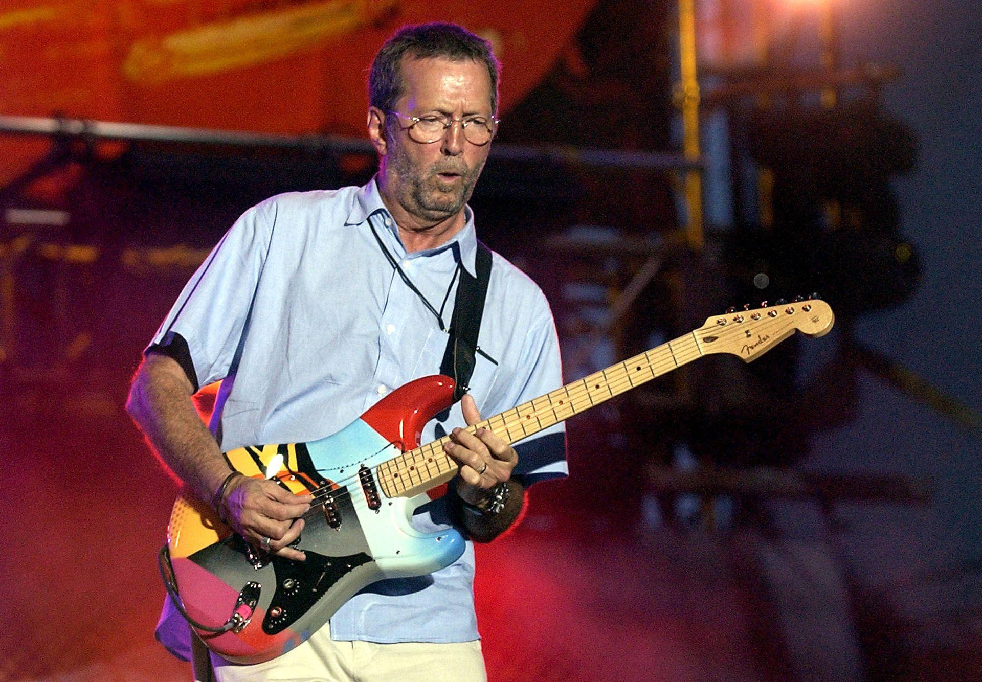 Eric Clapton Rocking Colorful Guitar Background