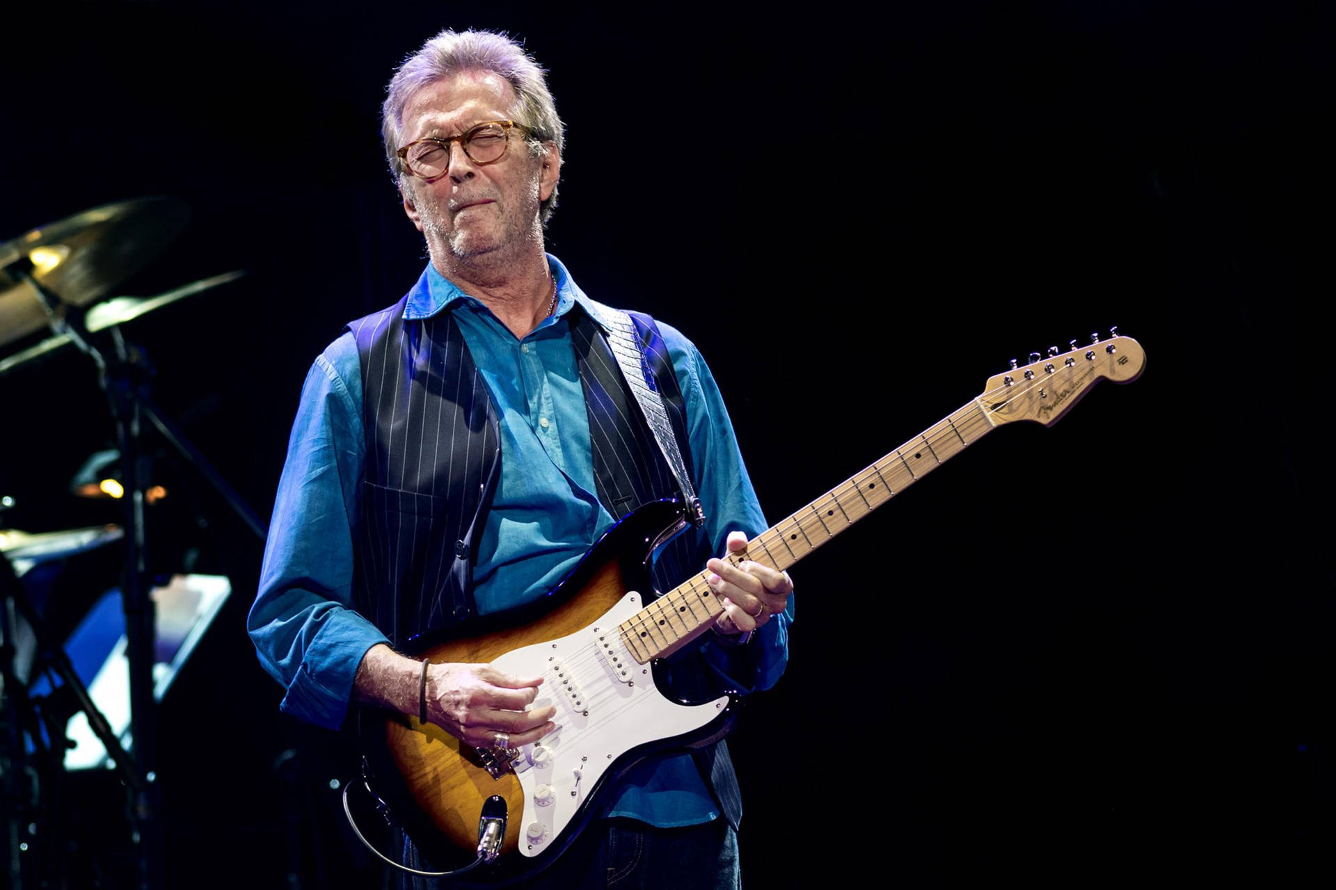 Eric Clapton Striking A Pose In His Signature Blue Polo