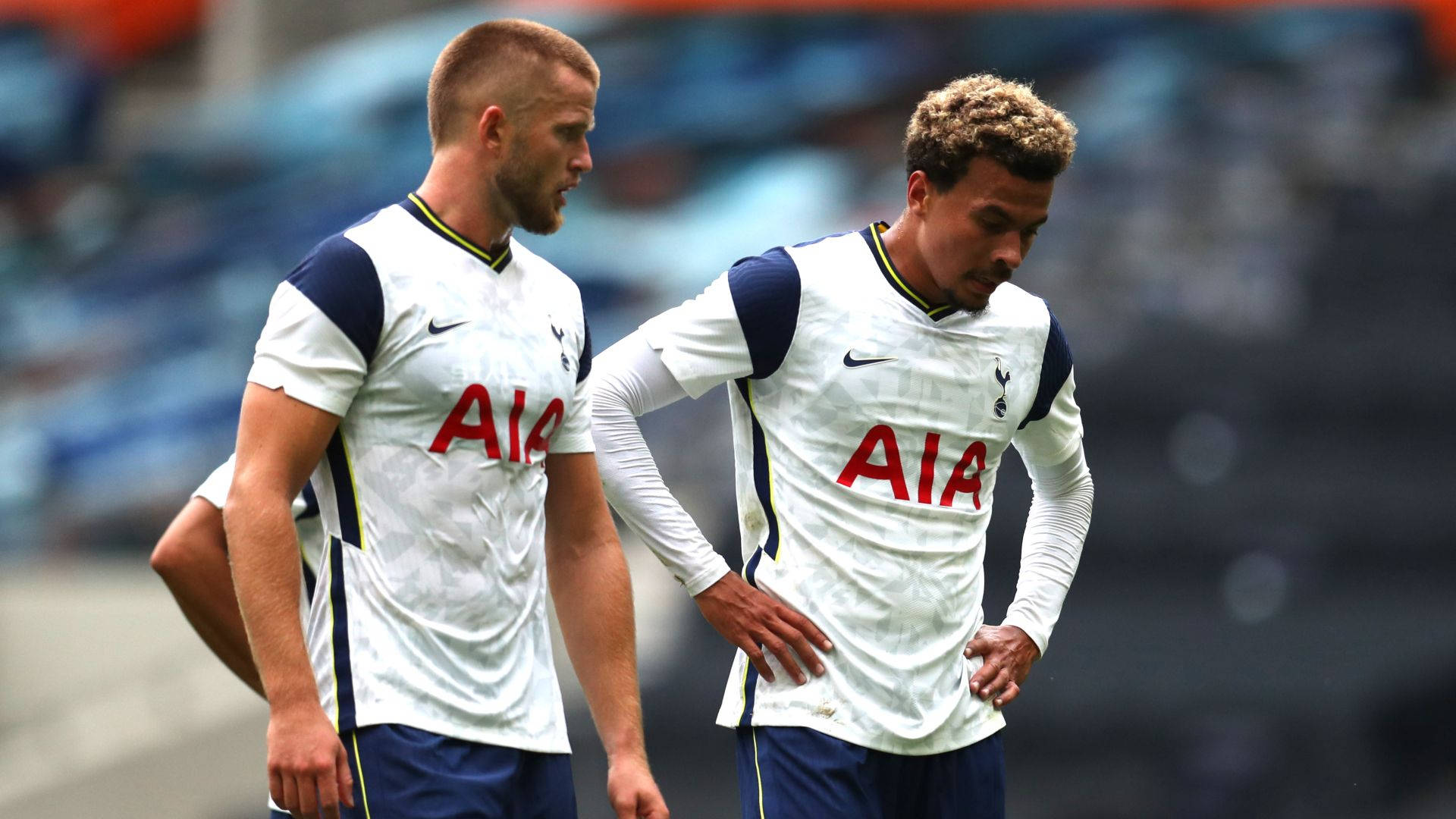 Eric Dier Walking With Teammate Background