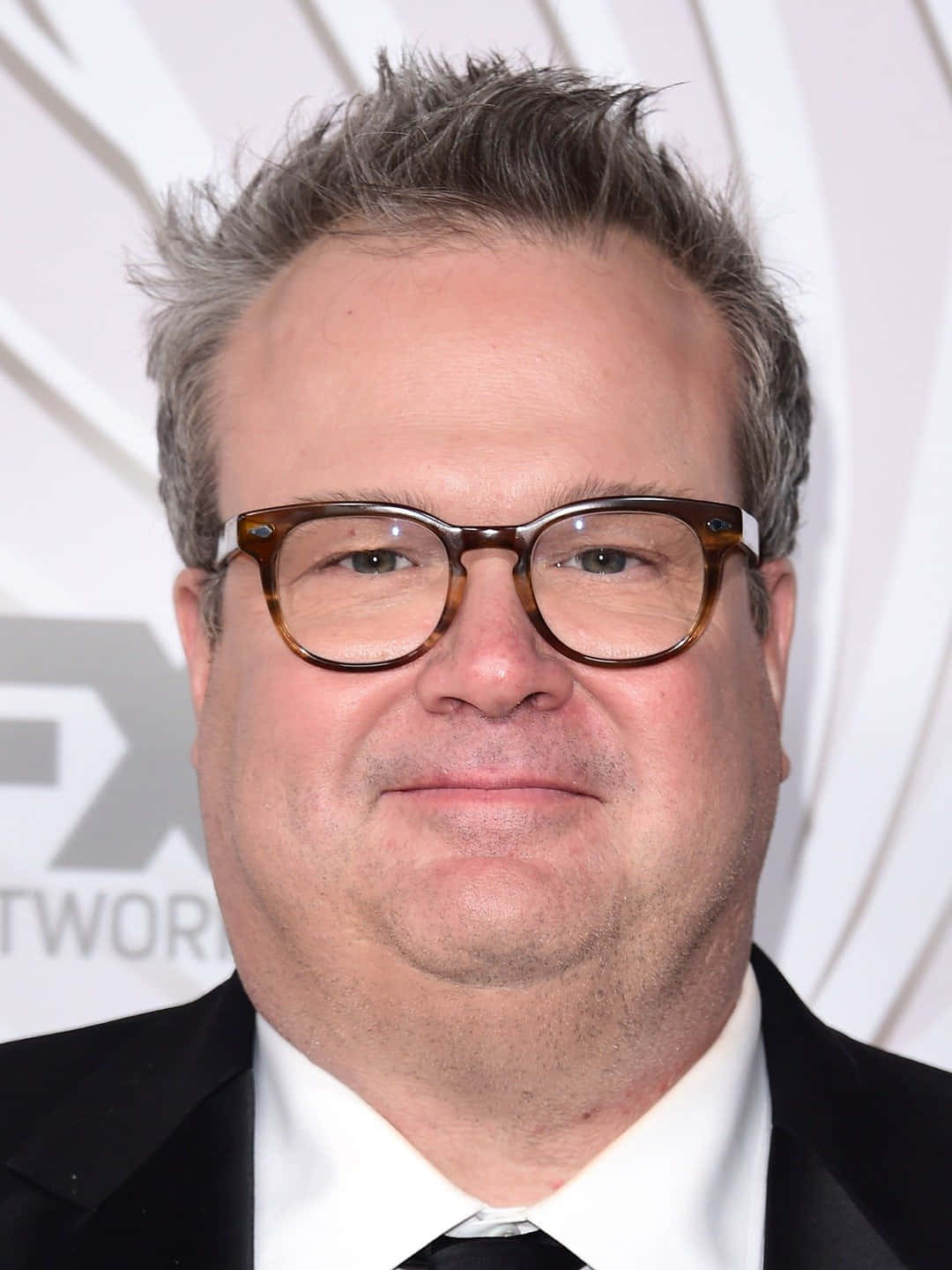 Eric Stonestreet, Star Of Modern Family, Smiling Brightly Background
