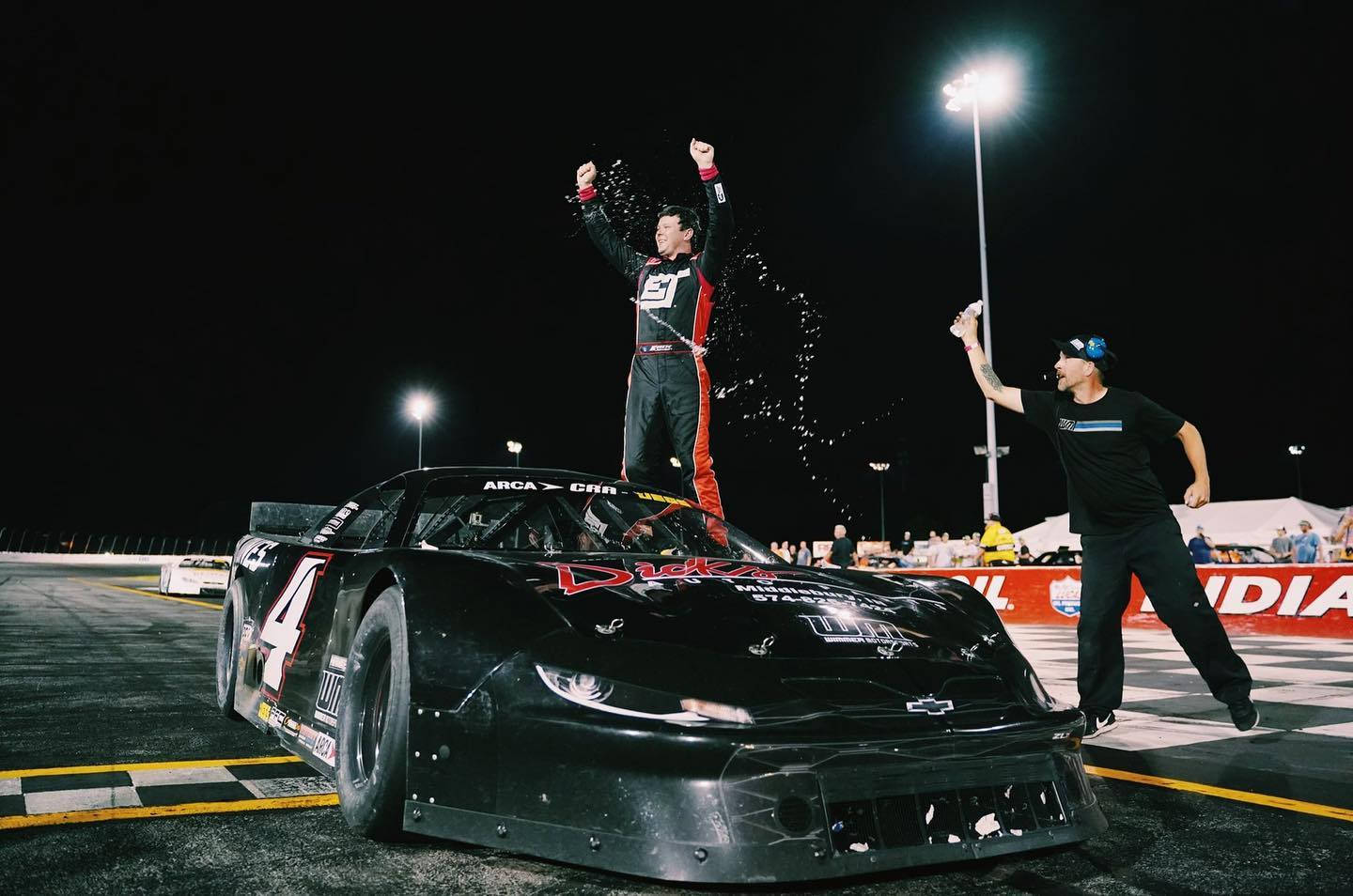 Erik Jones Above His Black Car