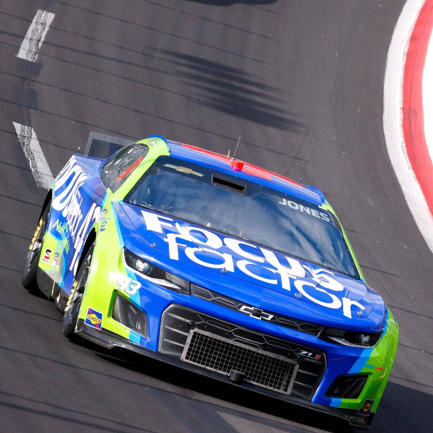 Erik Jones' Car Roaring On The Road Background